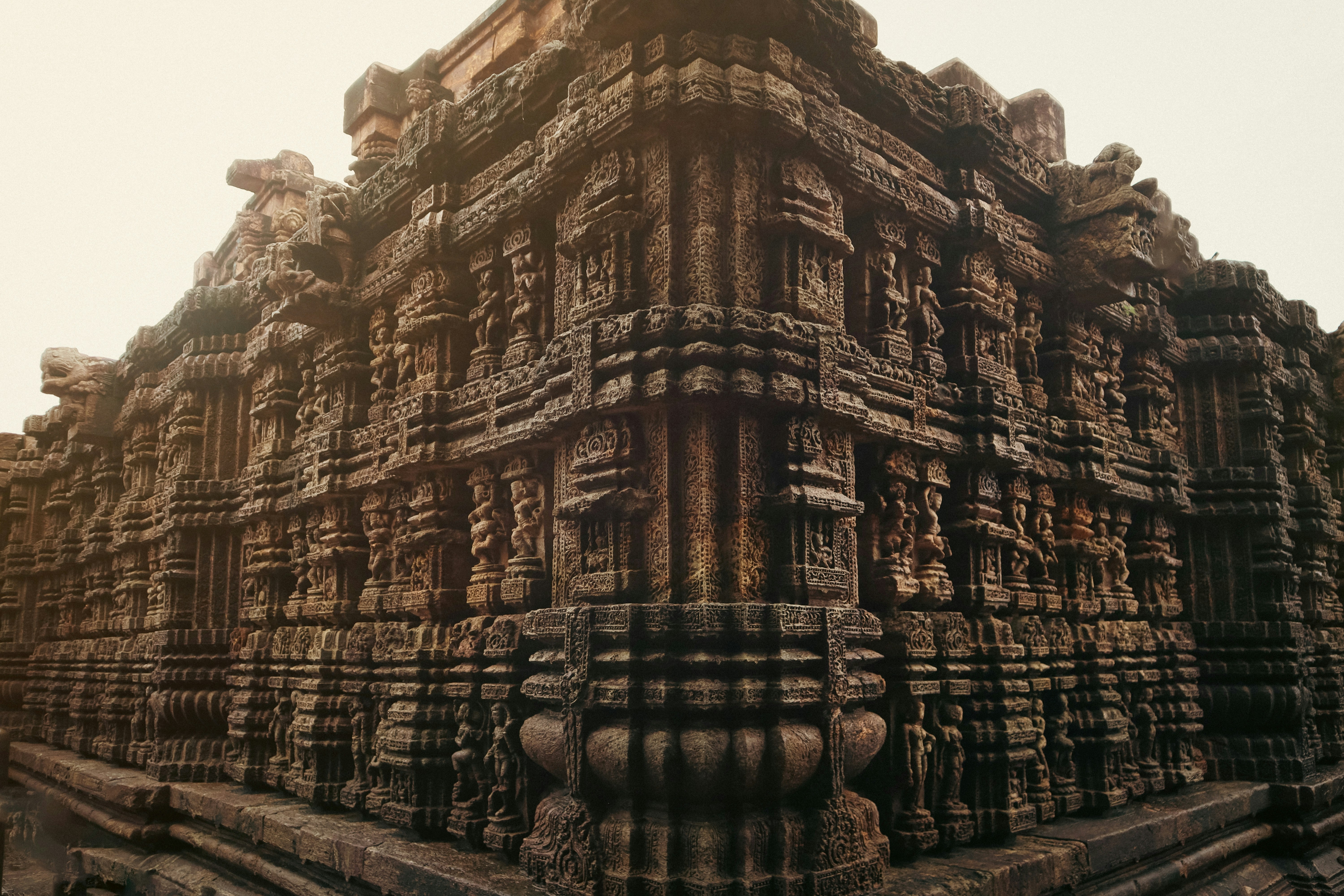 Ancient stone temple corner with detailed carvings.