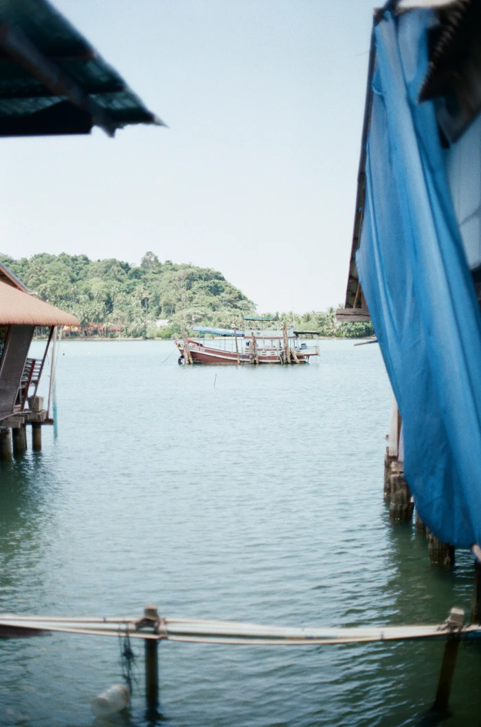 Traditional fishing boats moored near a waterfront village, similar to Corossol