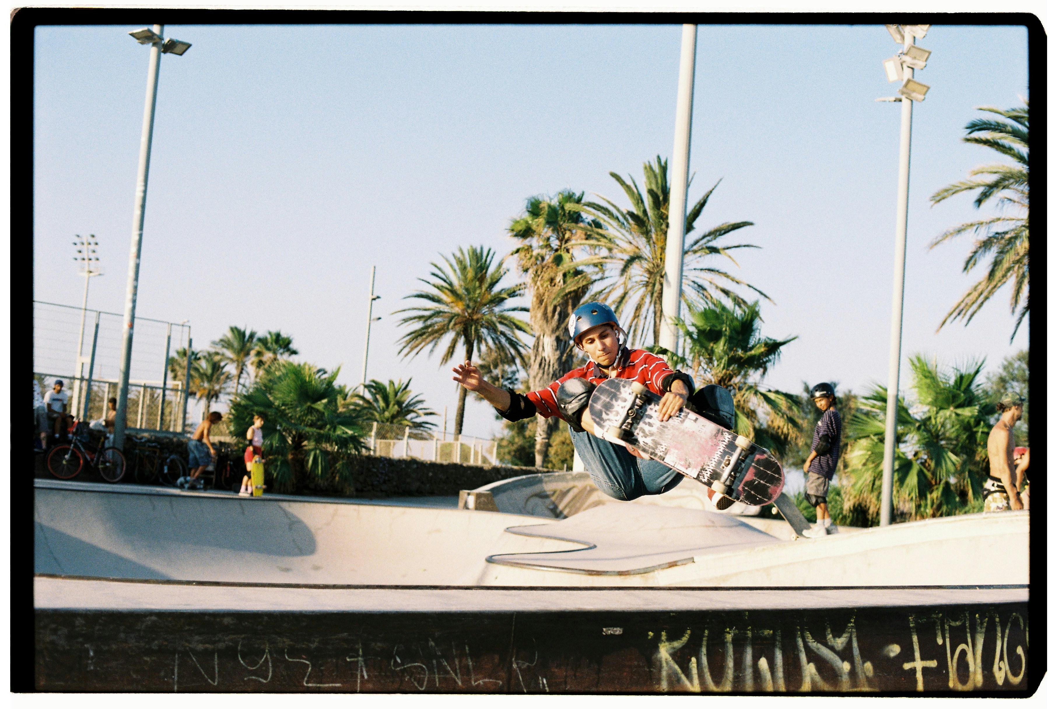 Skateboarder performs a trick in a bowl.