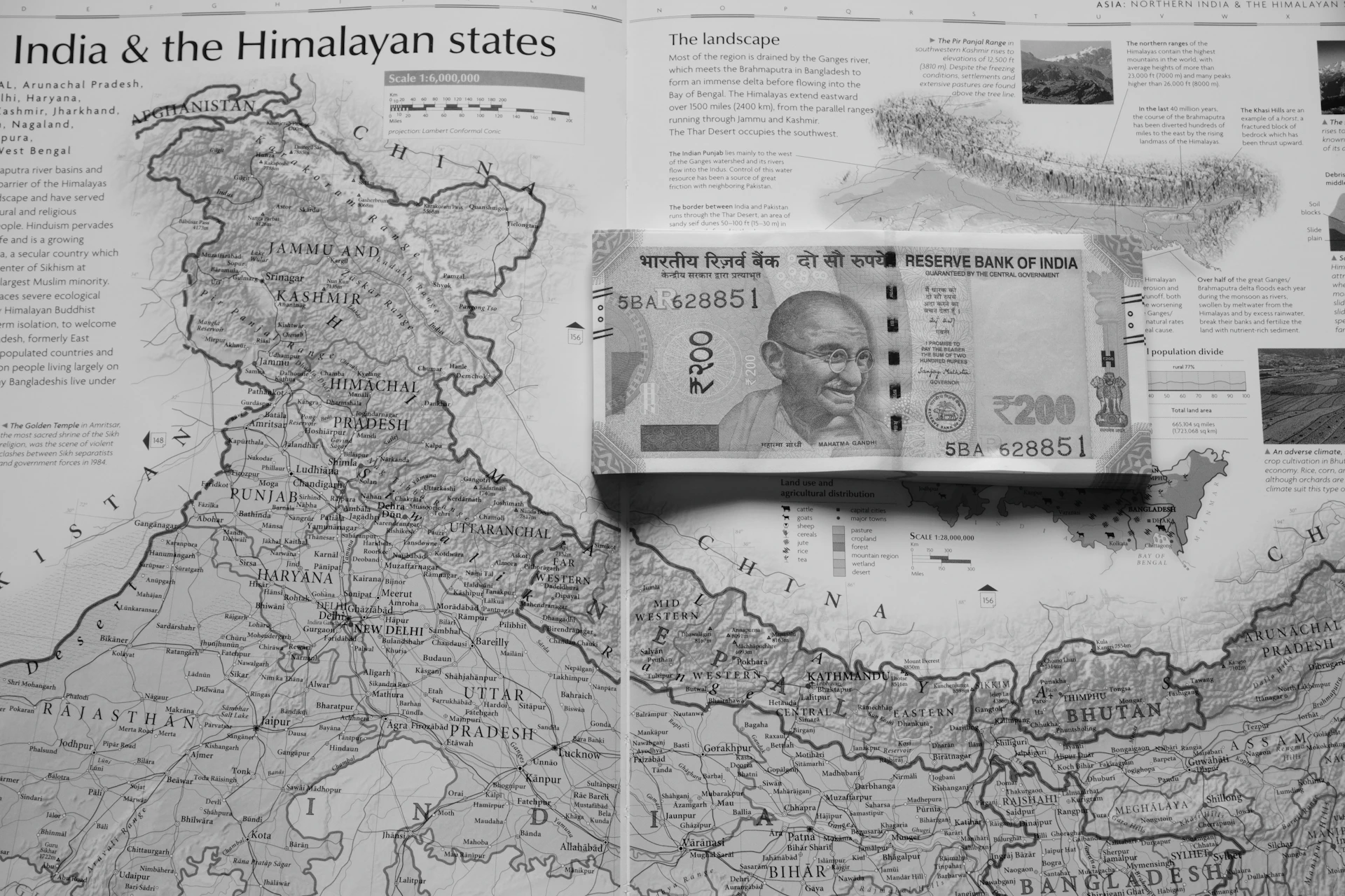 Indian currency rests on a map of india