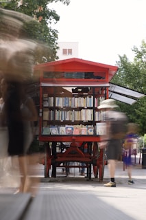 A red book cart sits outside, books available.