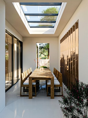 Elegant dining area with an overhead skylight.