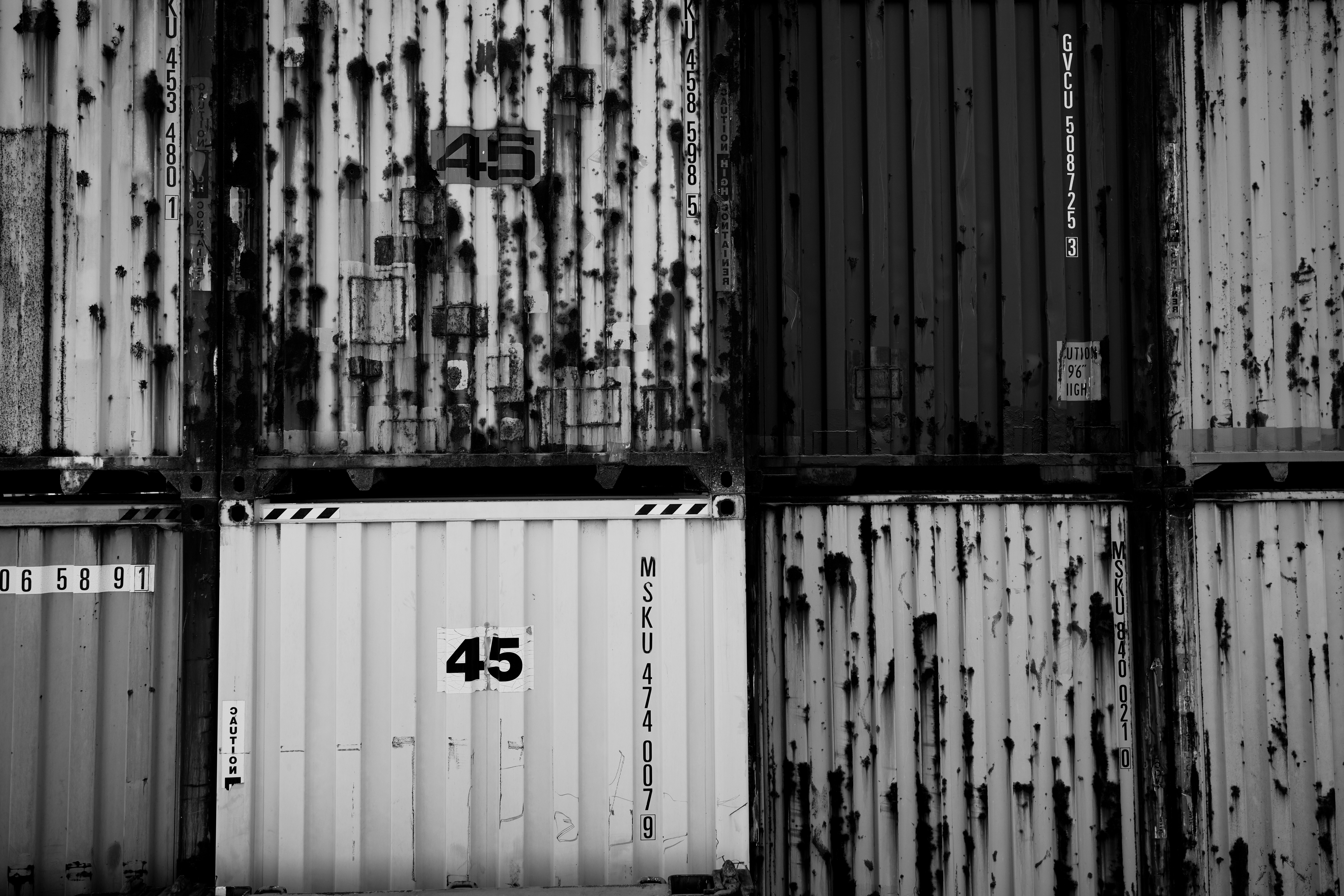 Rusted shipping containers are stacked together. photo – Free Building ...