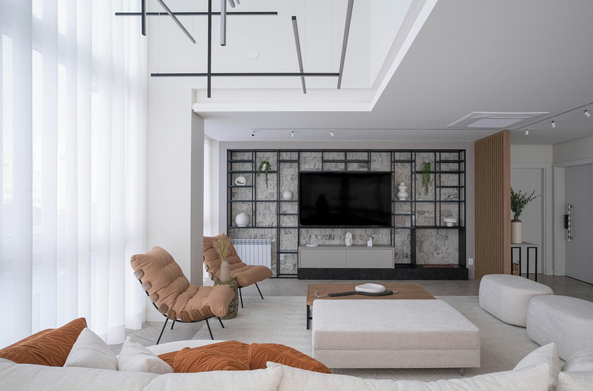A modern, stylish living room with soft lighting.