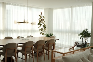 A bright, modern dining room with large windows.