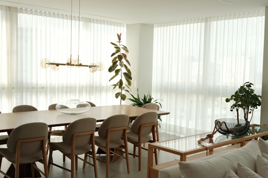 A bright, modern dining room with large windows.