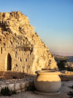 Ancient stone ruins and a large jar stand together.