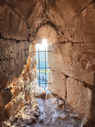 Window in a stone wall with a view.