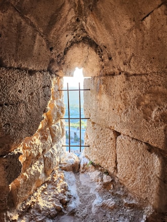 Window in a stone wall with a view.
