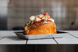 A delicious lobster roll on a plate.