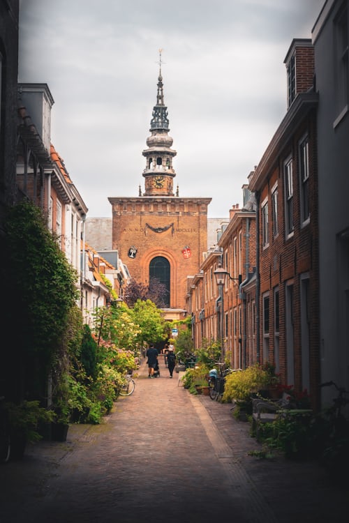 A narrow street in Haarlem with historic brick buildings and a bicycle parked by a door