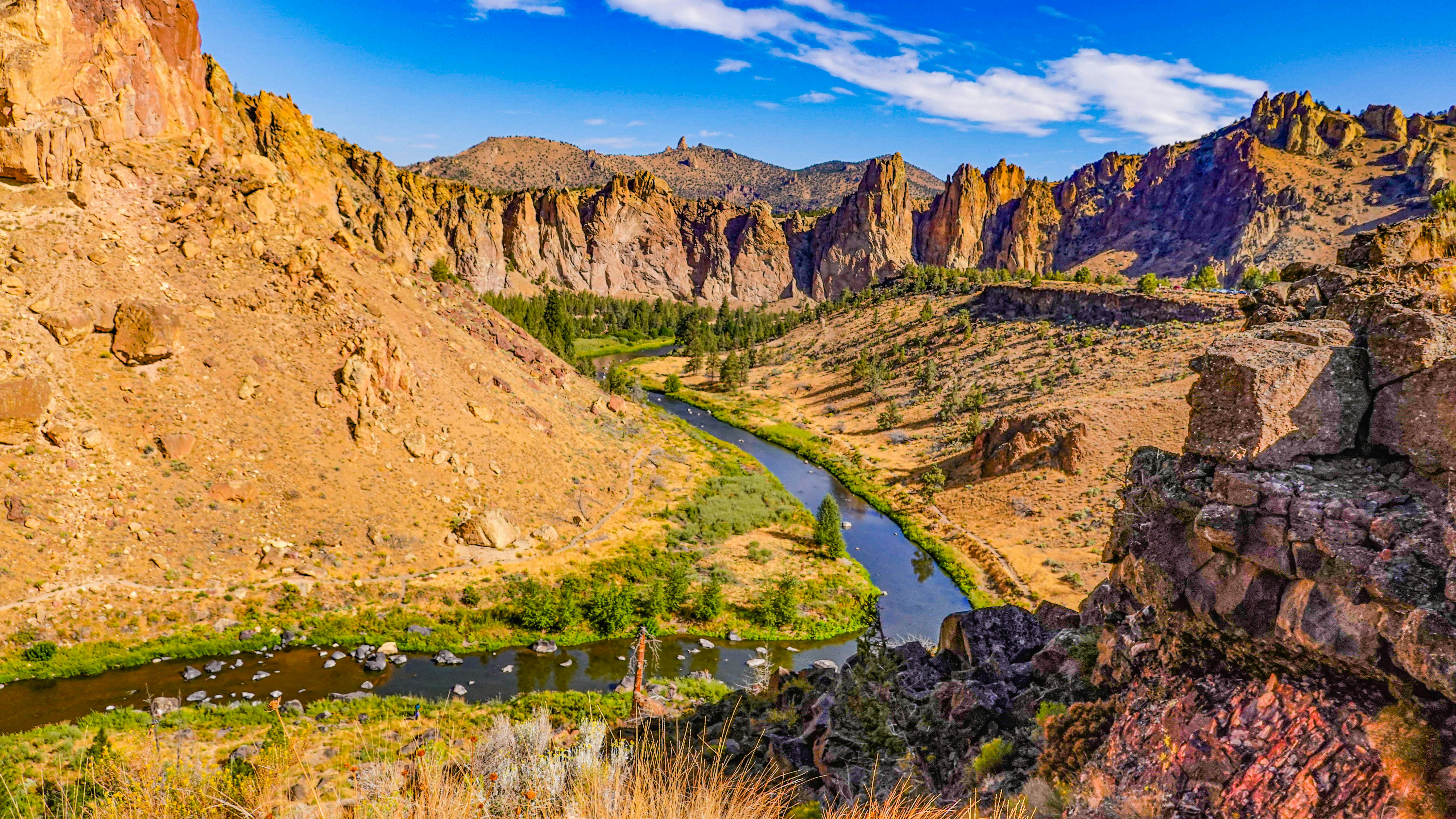 A river winds through a rugged canyon landscape.