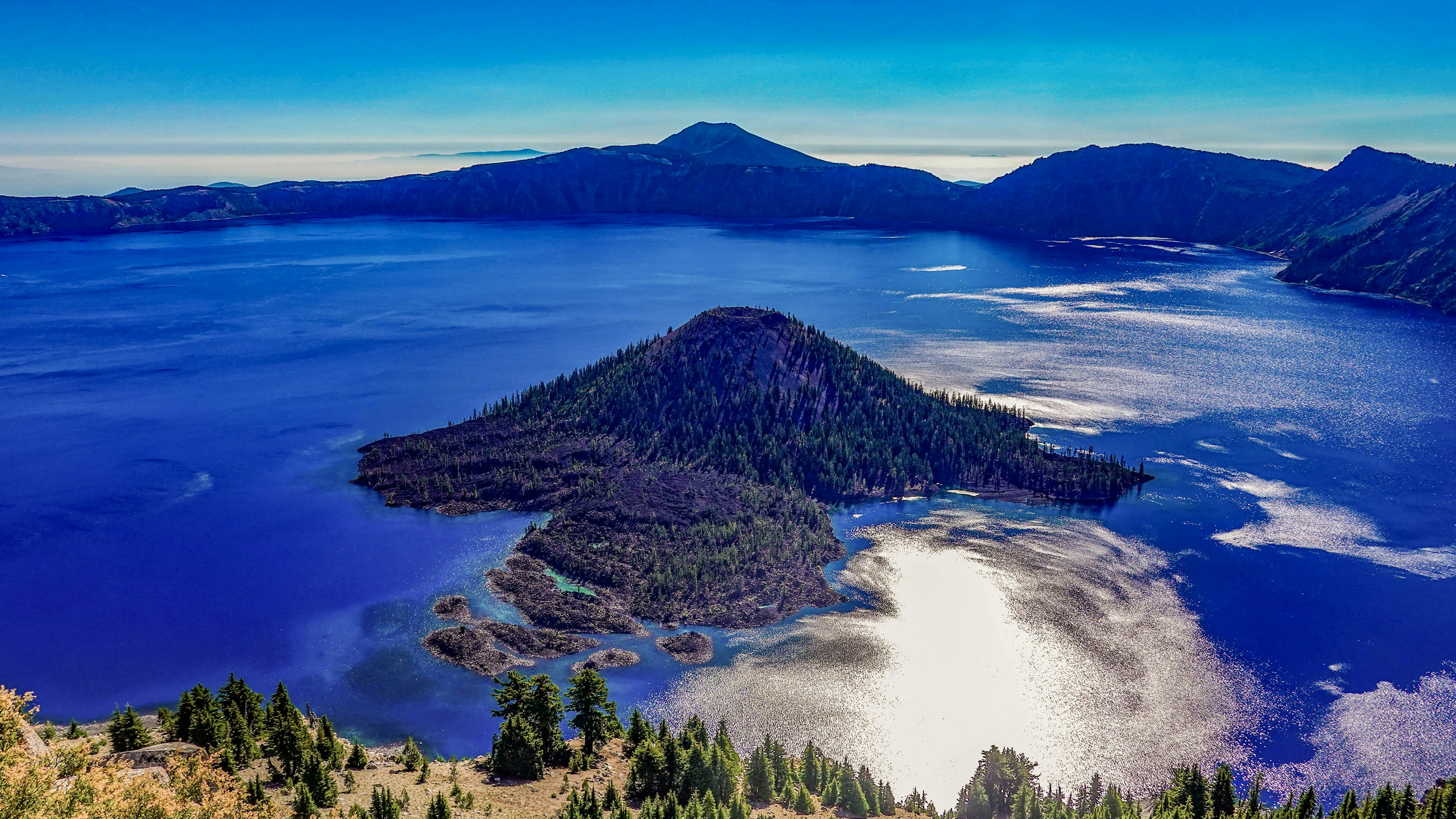 A scenic view of crater lake with an island.