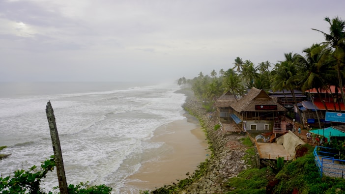 Beach houses sit along the stormy coast.