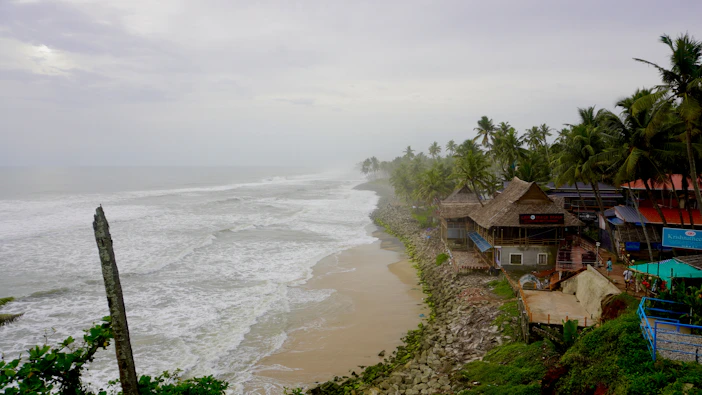 Beach houses sit along the stormy coast.