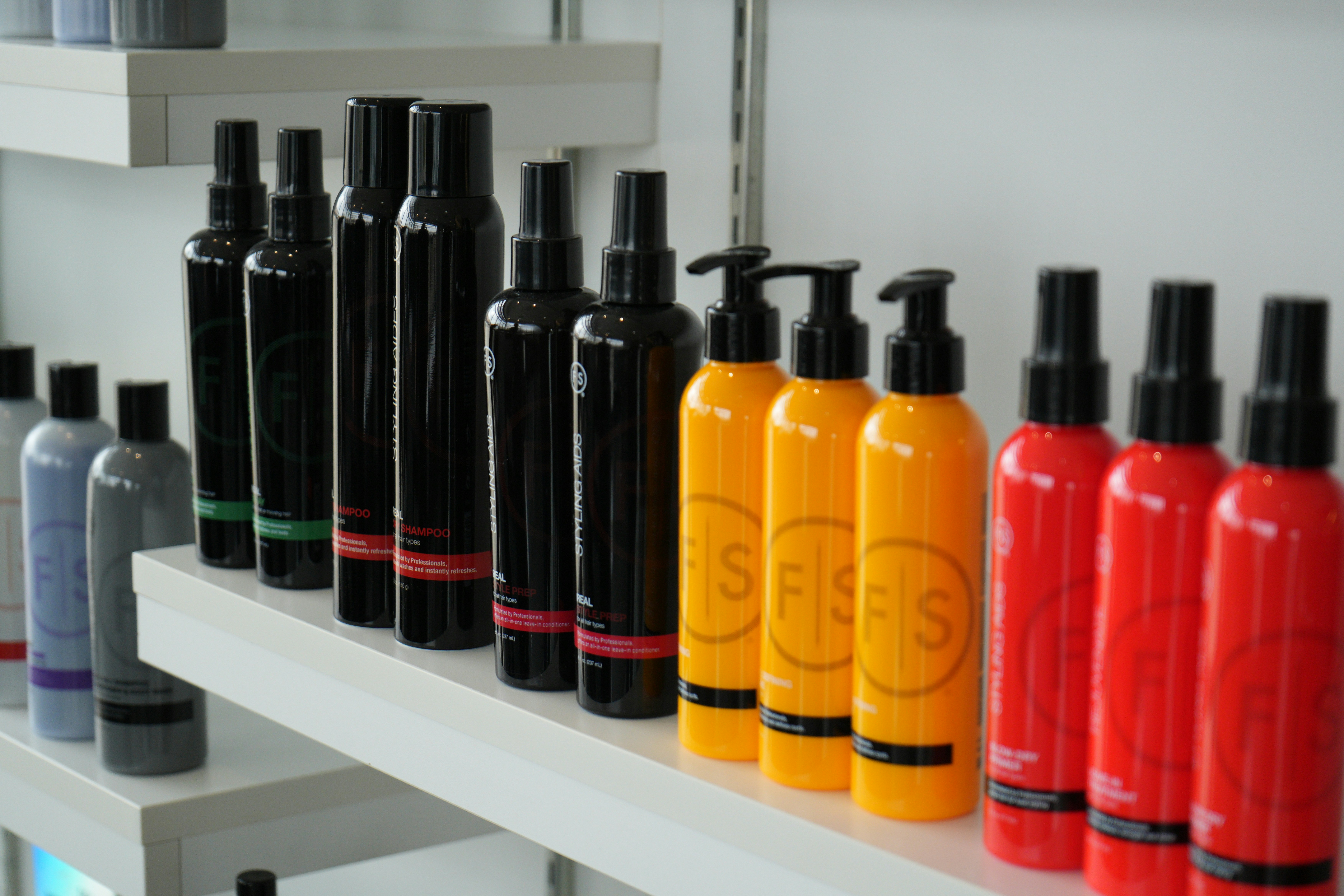 Hair care products are displayed on a shelf.
