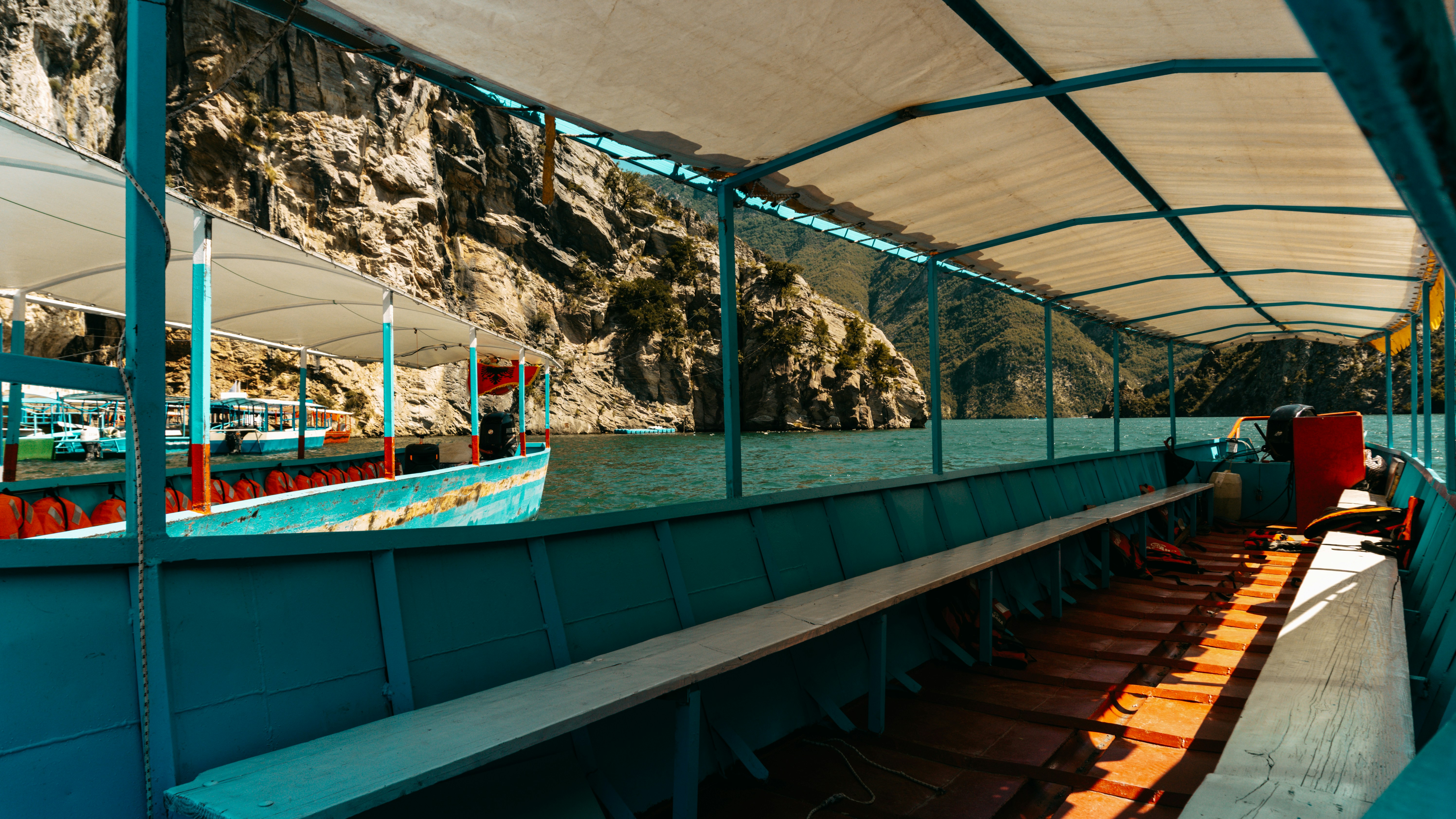 Inside a boat with benches, overlooking water