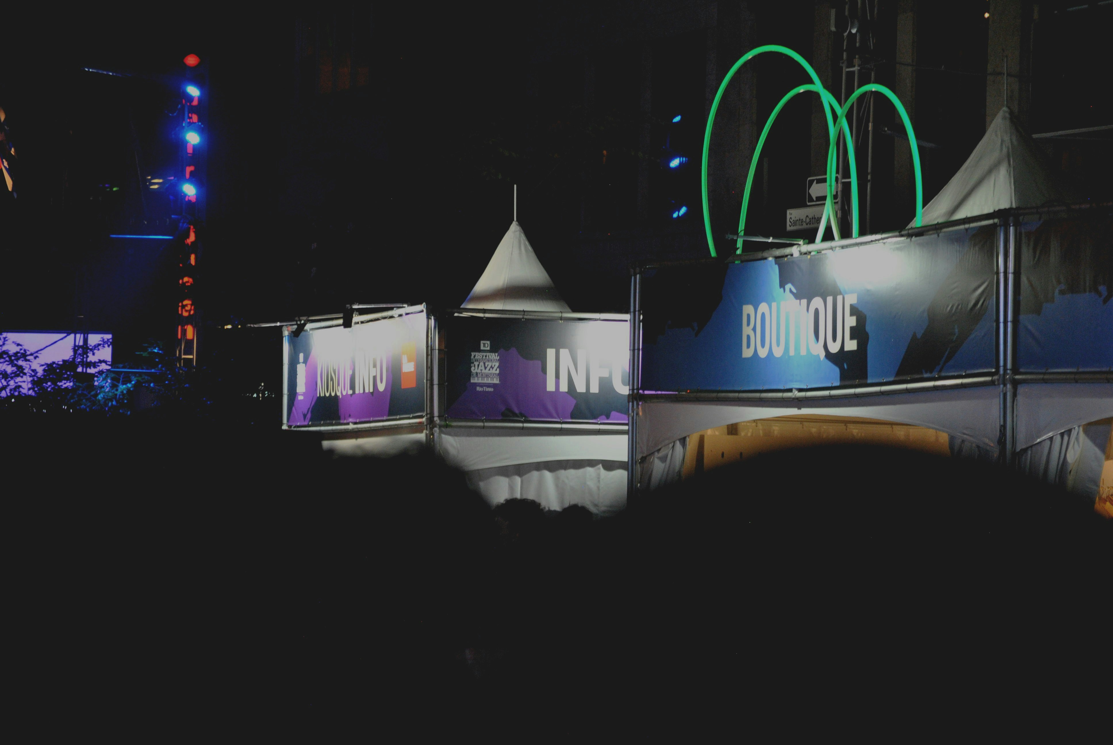 Event stalls lit up at night.