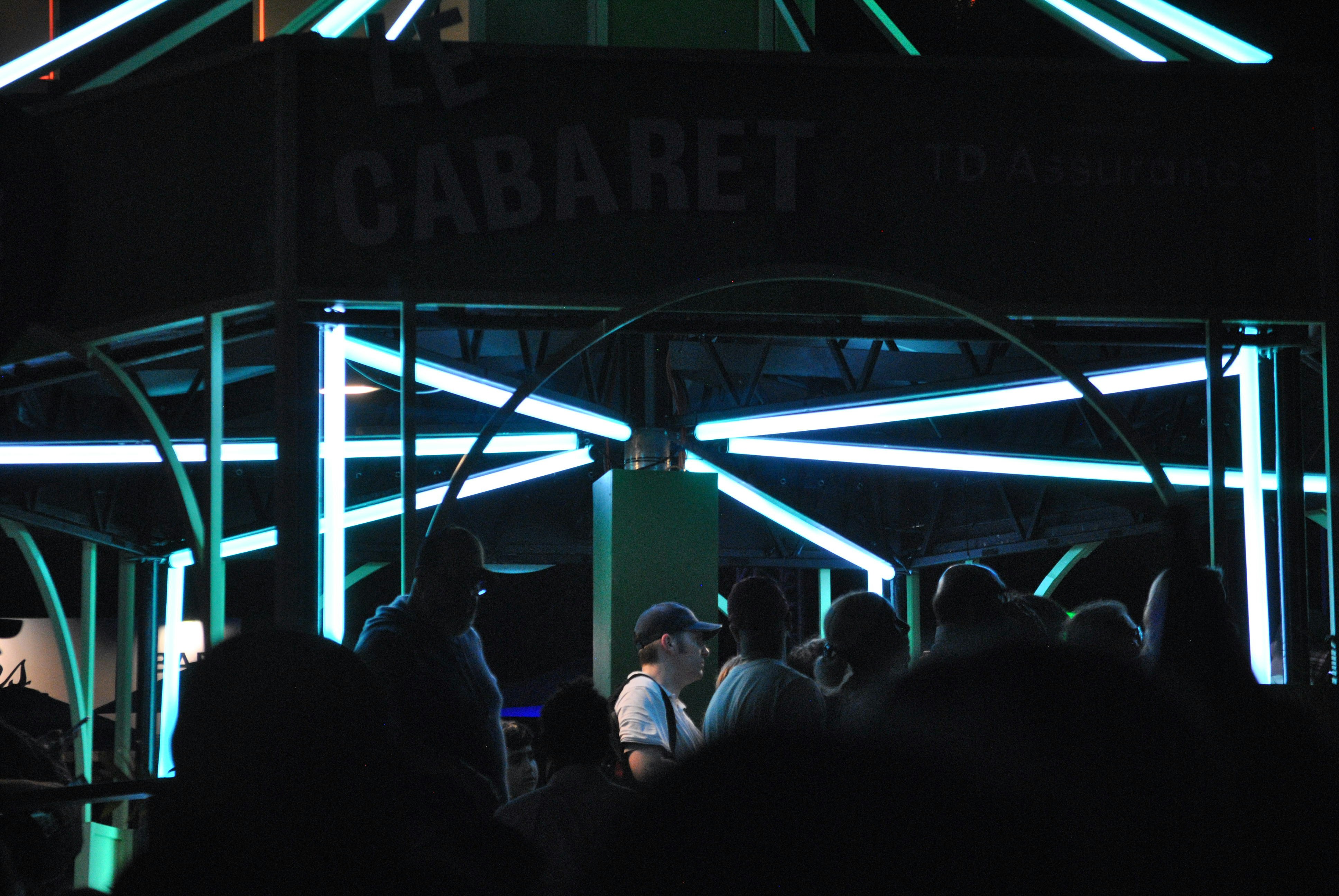 People are gathered outside "le cabaret" at night.