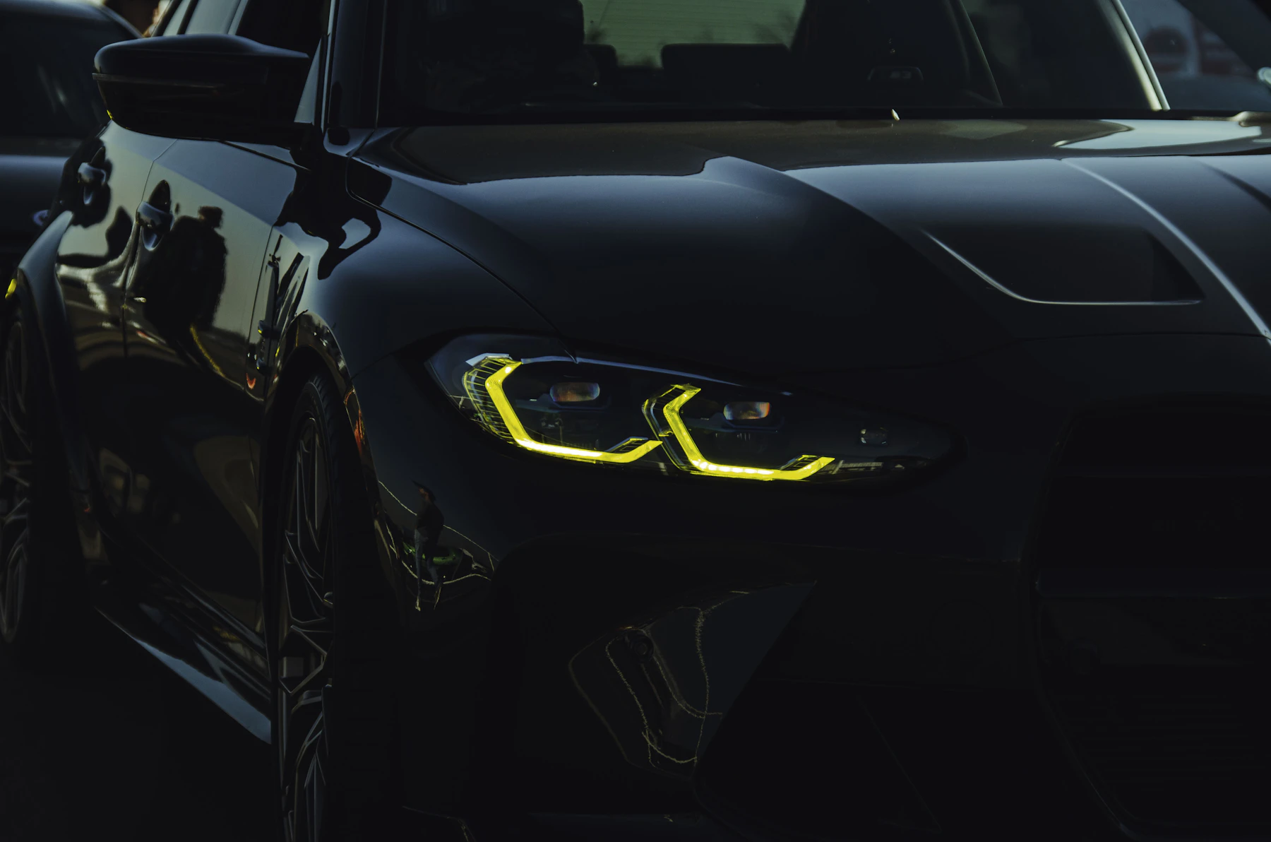 Detailed car exterior with glowing headlights at night