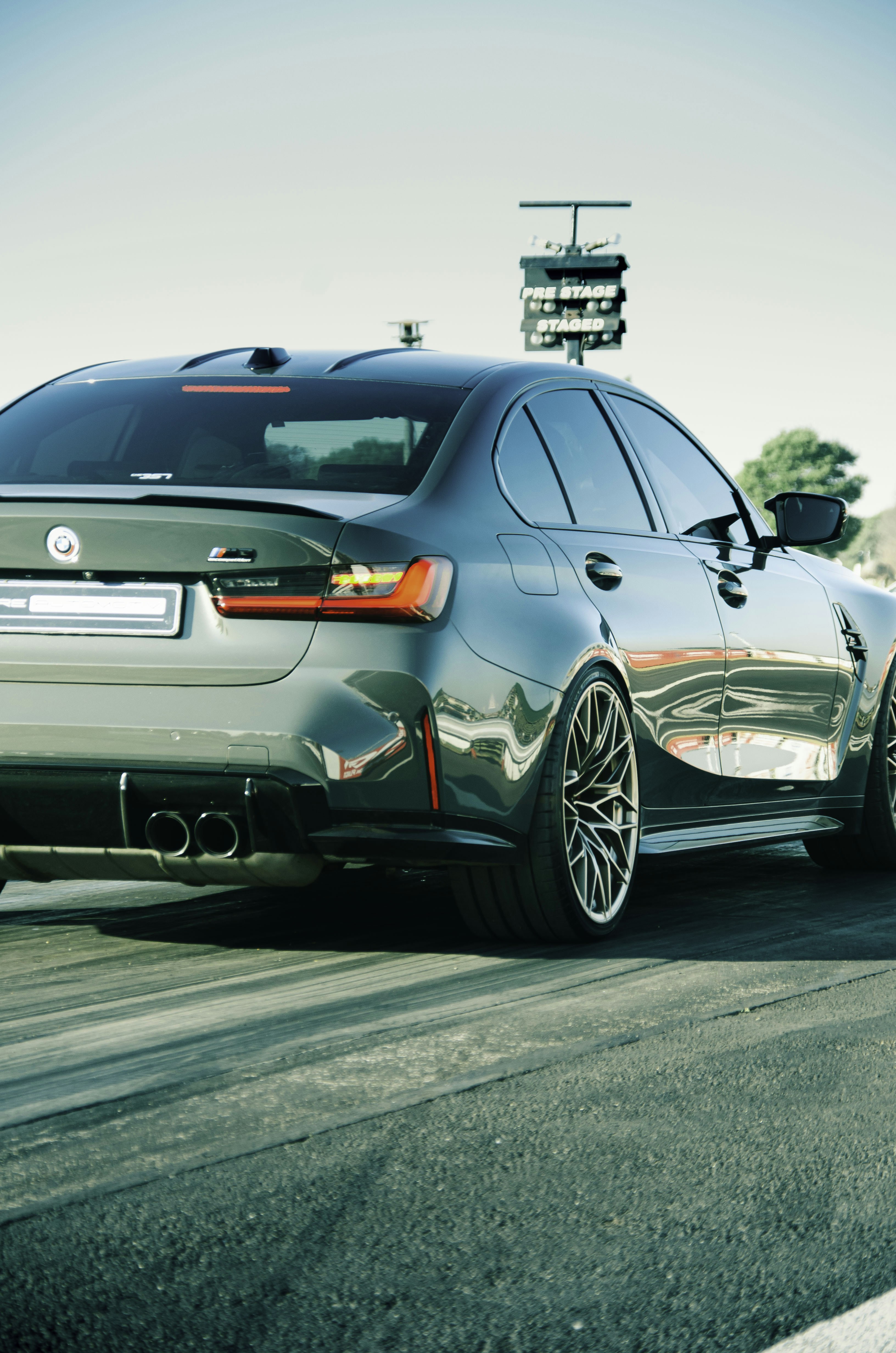 A sleek, sporty BMW car races on a track.