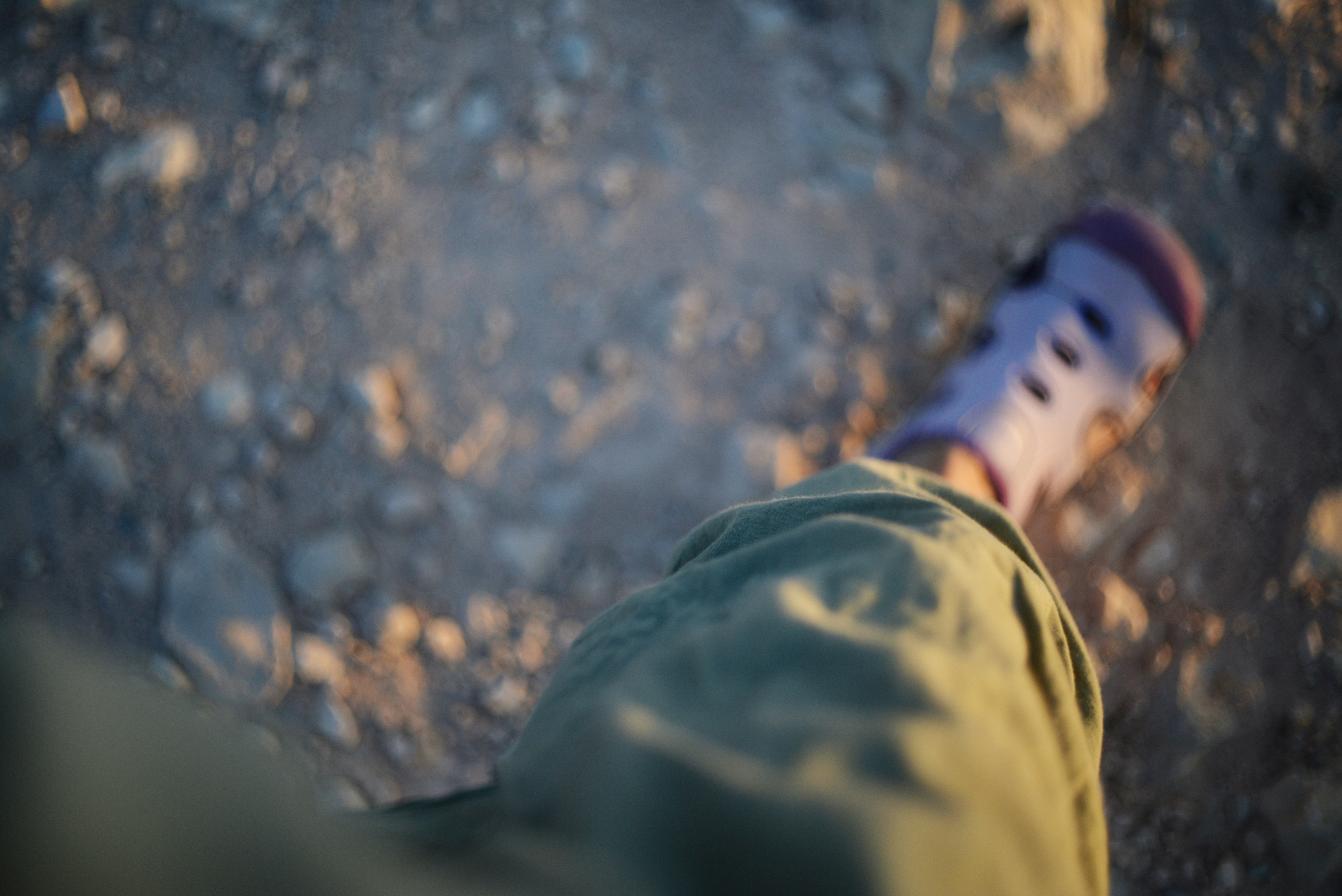 A close-up shot of an NDRF team member, covered in dirt and sweat, taking a moment's rest during the rescue operation, reflecting exhaustion and determination.