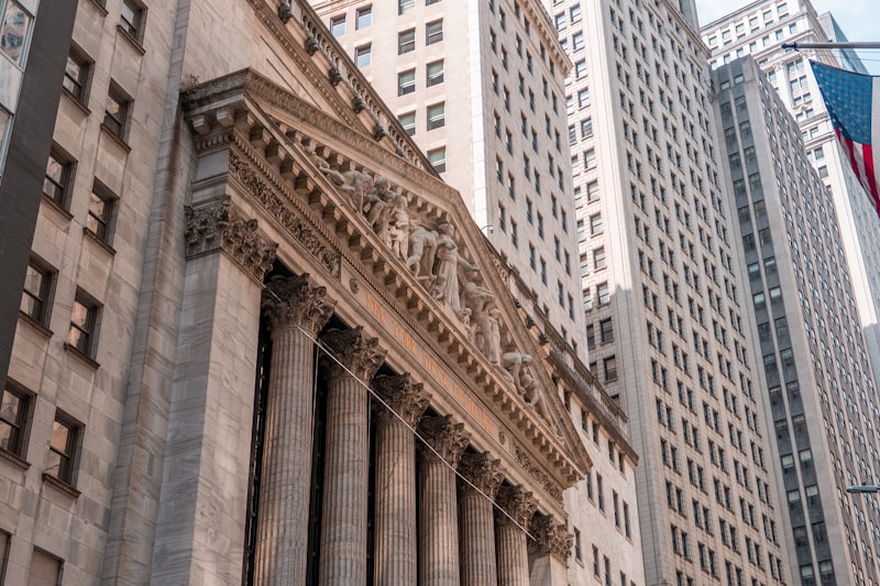Wall Street trading floor, stock market ticker, financial trading screens, New York Stock Exchange, line chart