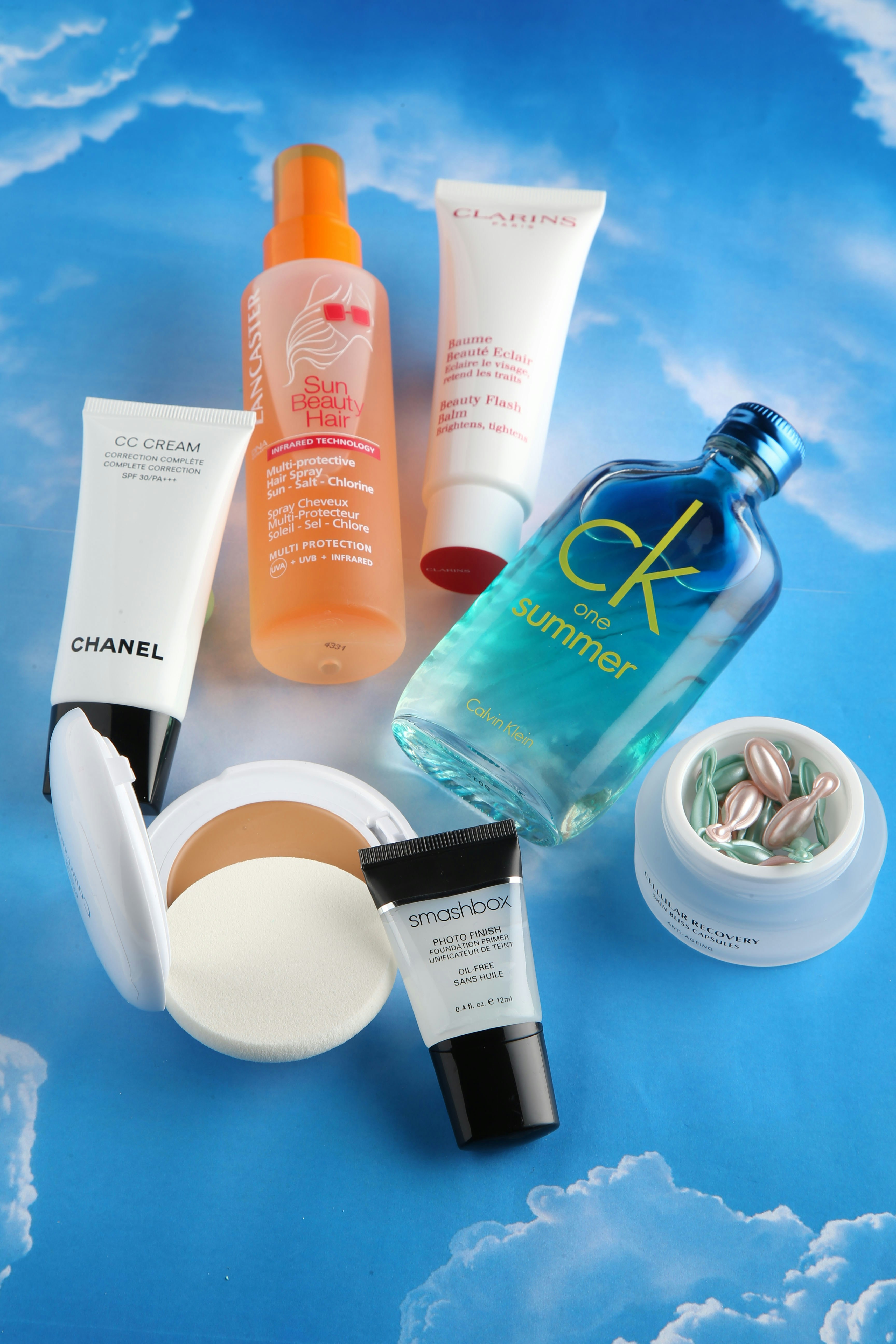 Cosmetics and beauty products arranged on a blue background