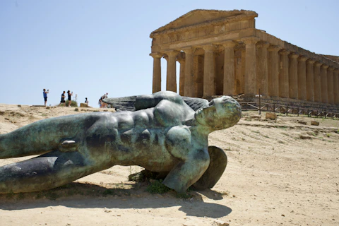 A statue lies near a temple ruin