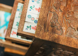 Mahjong tiles sit in an ornate wooden box.