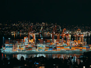 Nighttime view of a brightly lit cargo port