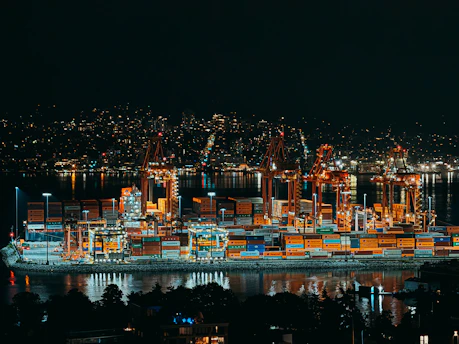 Nighttime view of a brightly lit cargo port