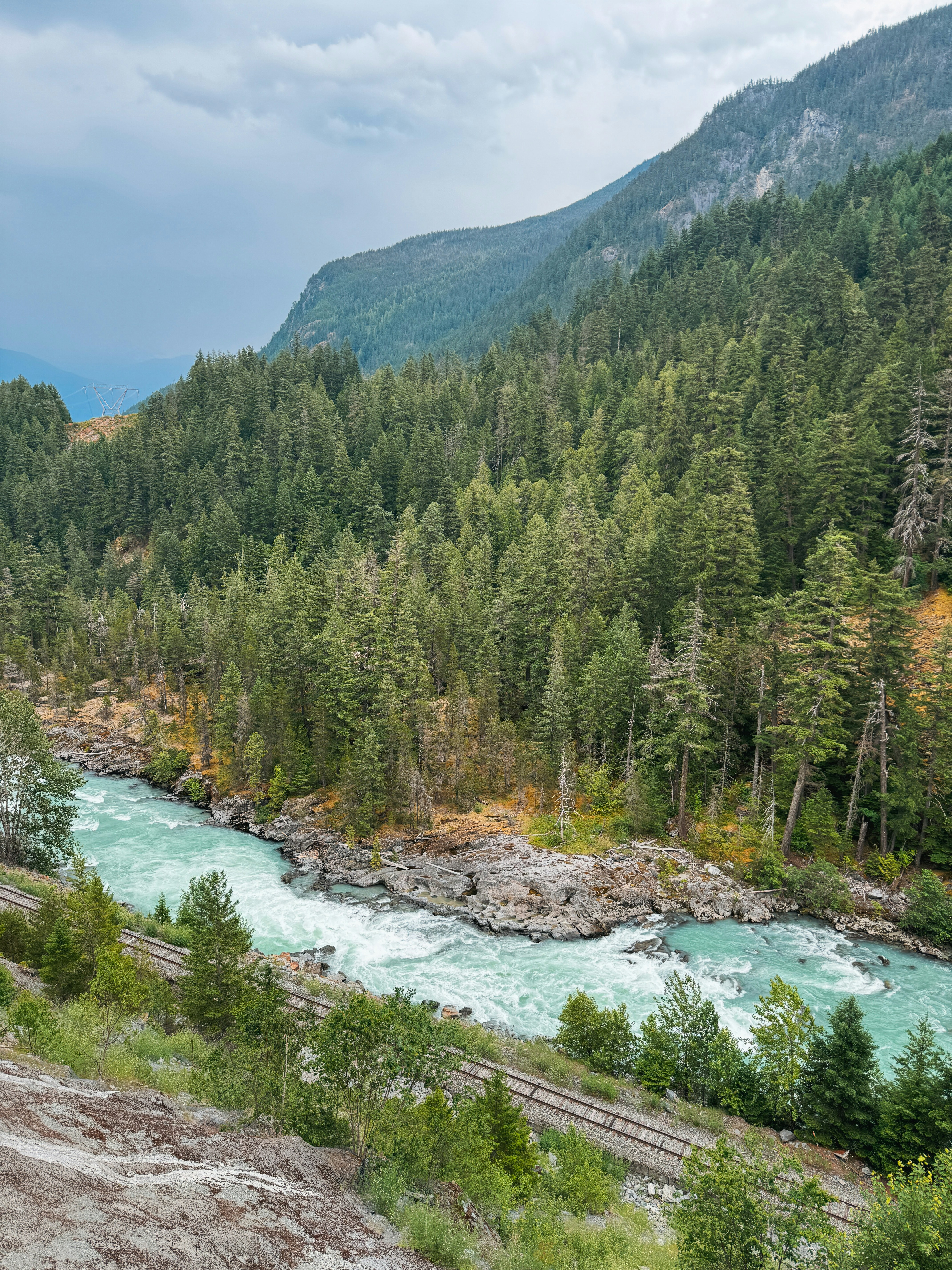 A river flows through a lush mountain landscape.