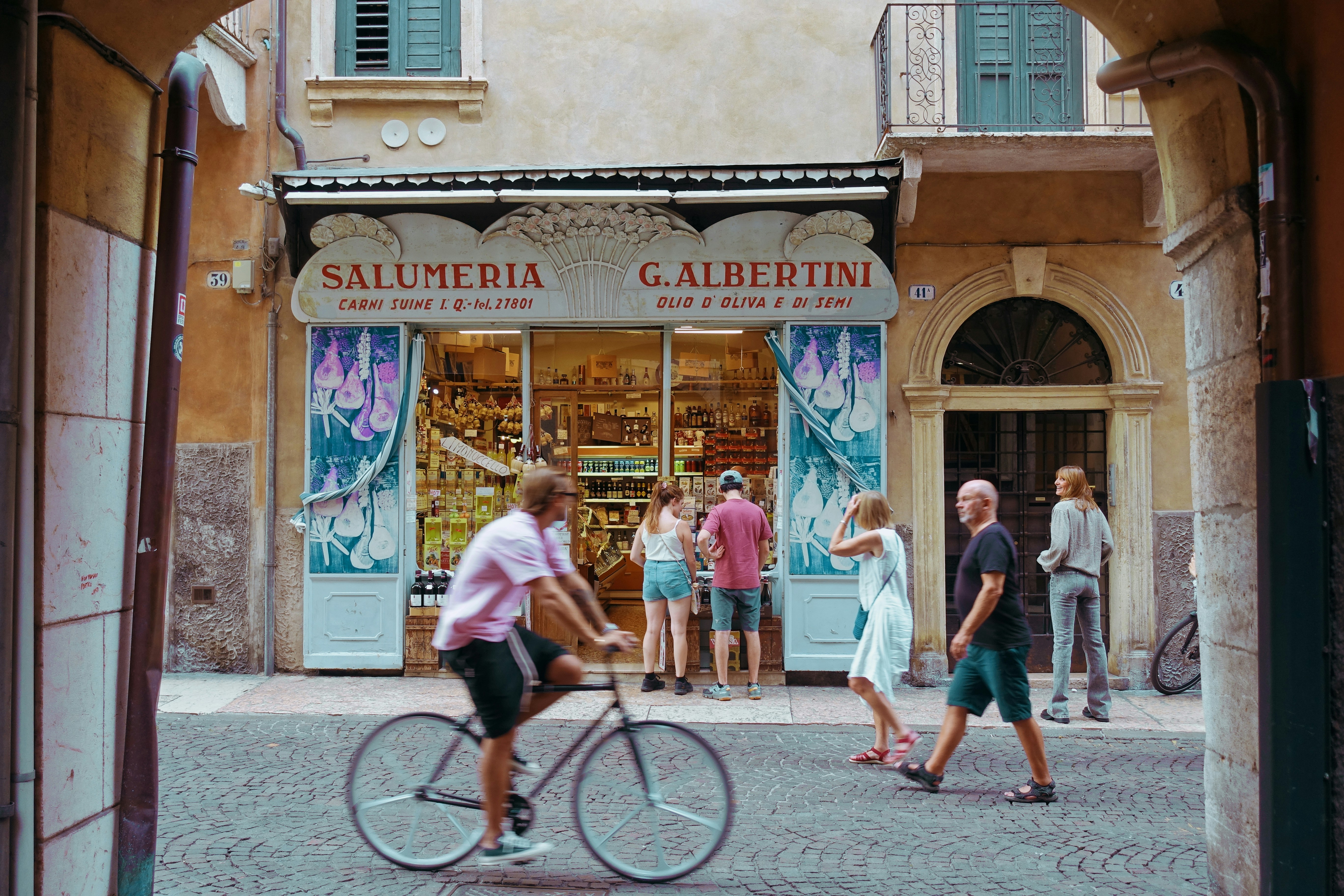 People are near a shop in a european city.