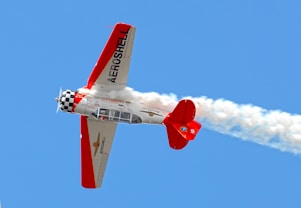 Aerobatic airplane performing maneuvers in the sky.