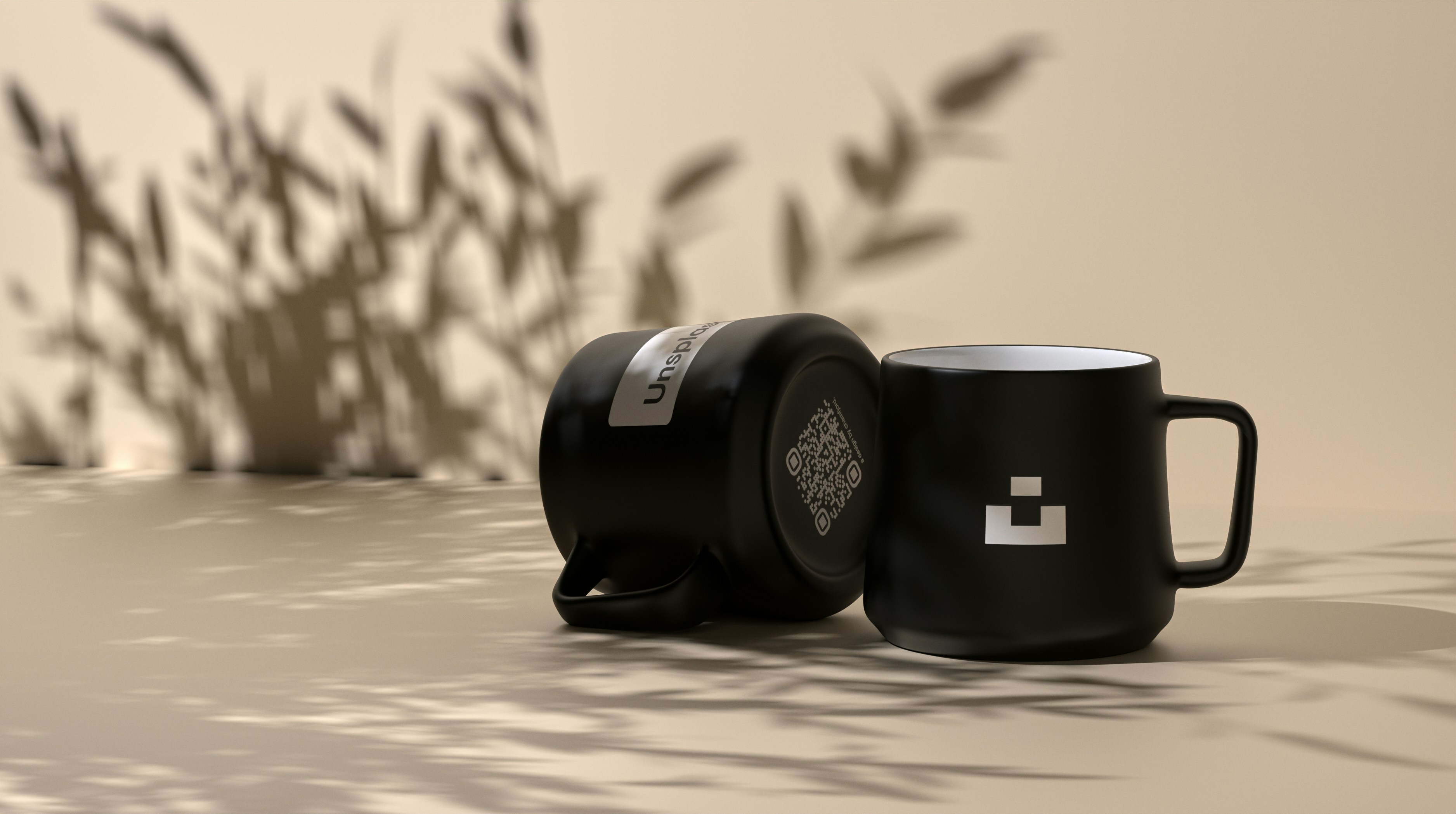 Black mug and speaker on beige background.