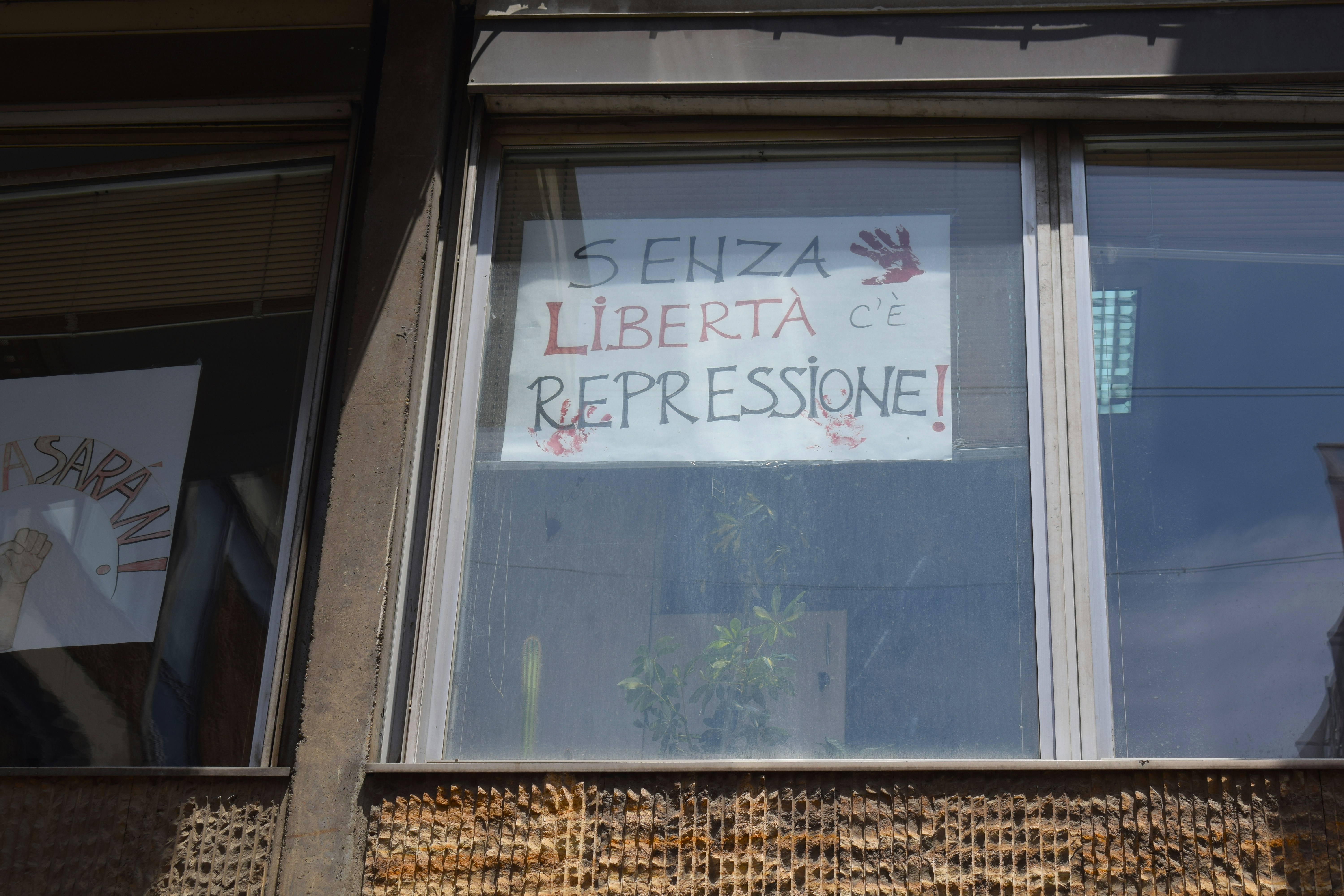 Window displays a sign about freedom and repression. photo – Free ...