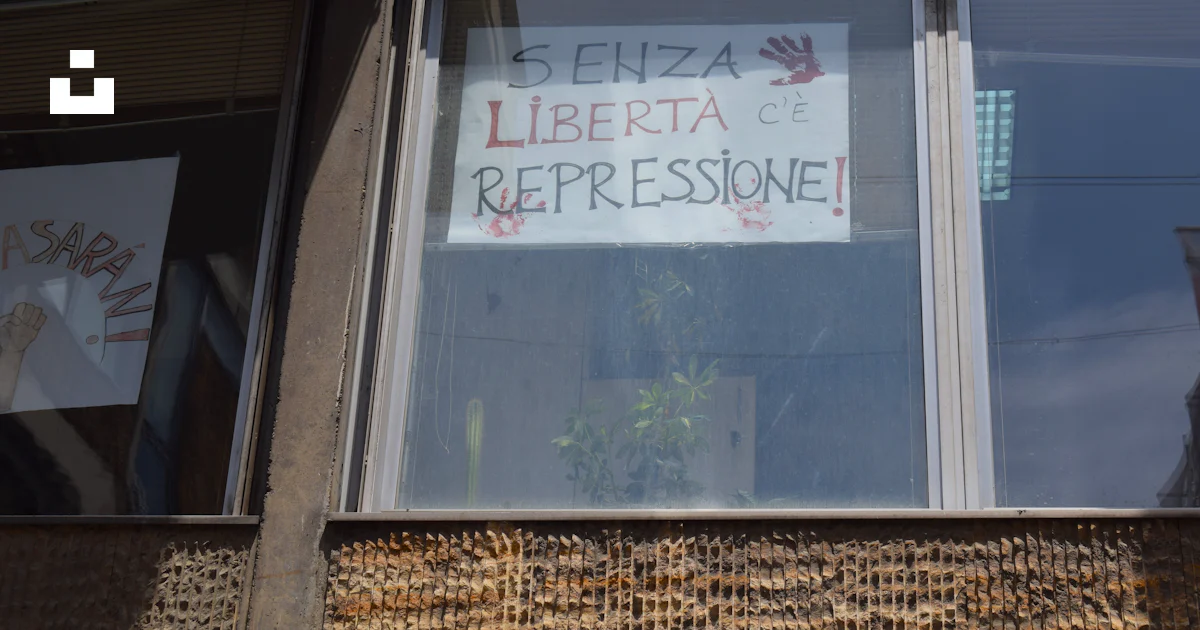 Window displays a sign about freedom and repression. photo – Free ...