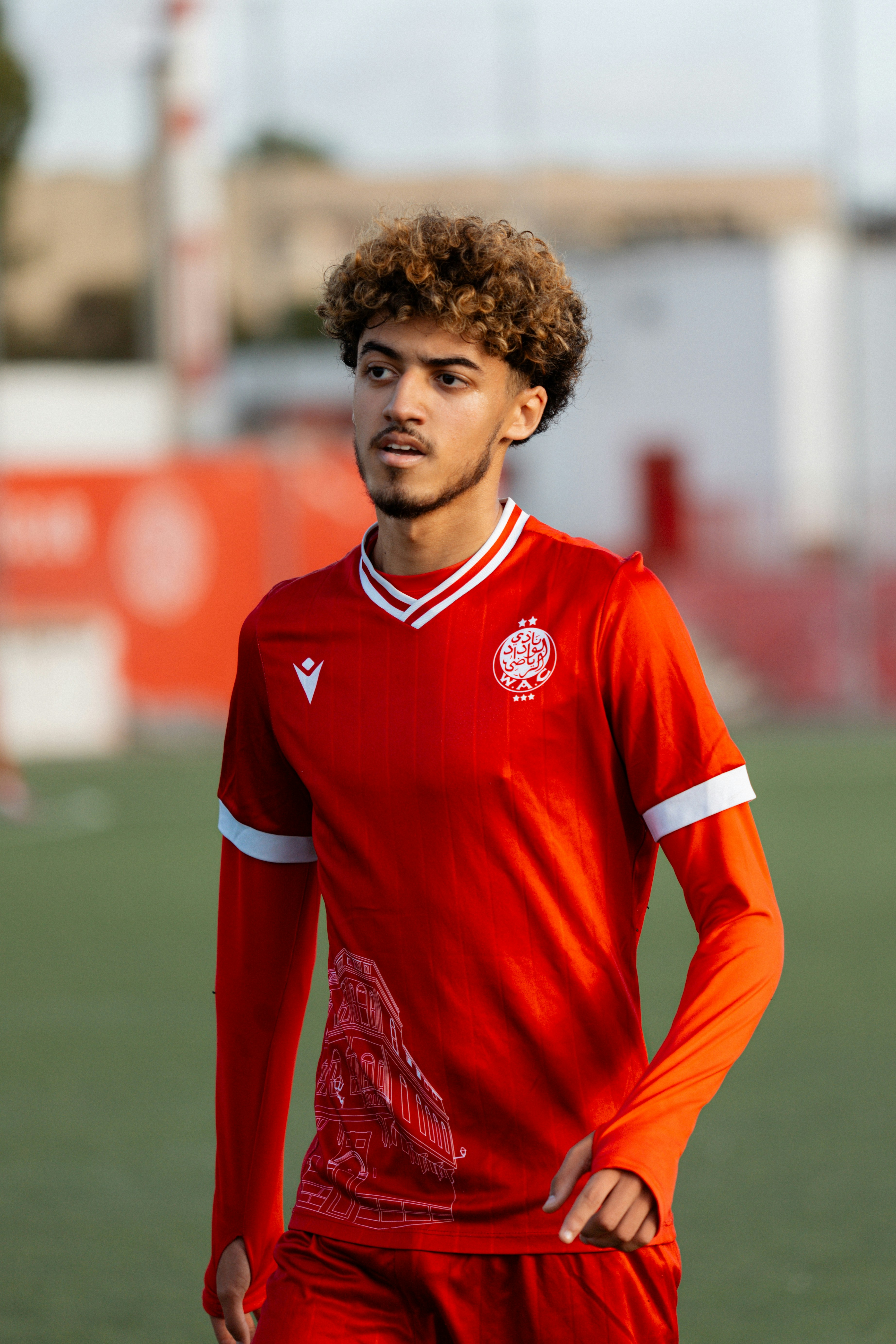 A soccer player stands on the field.