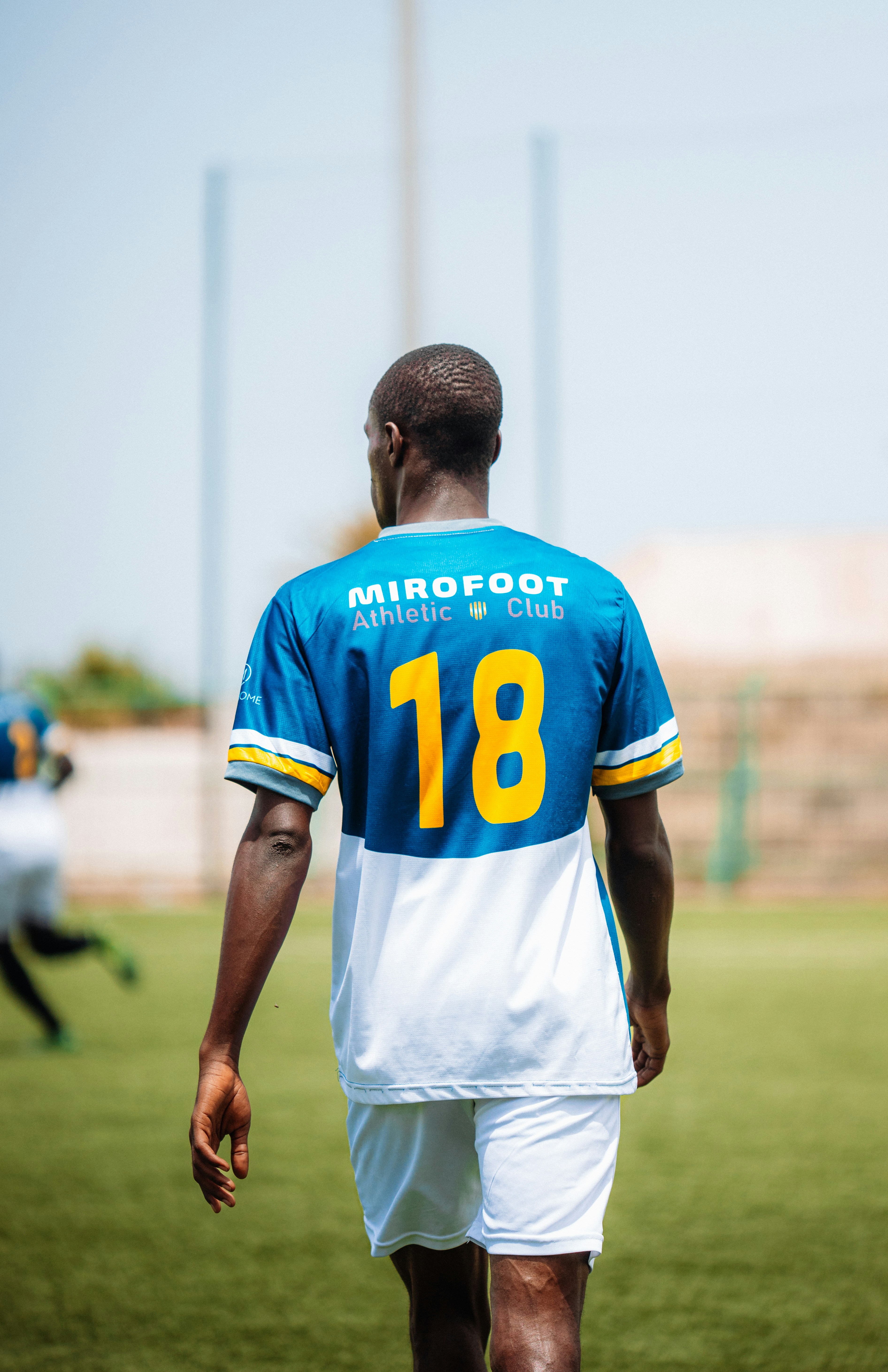 A soccer player wearing jersey number 18.