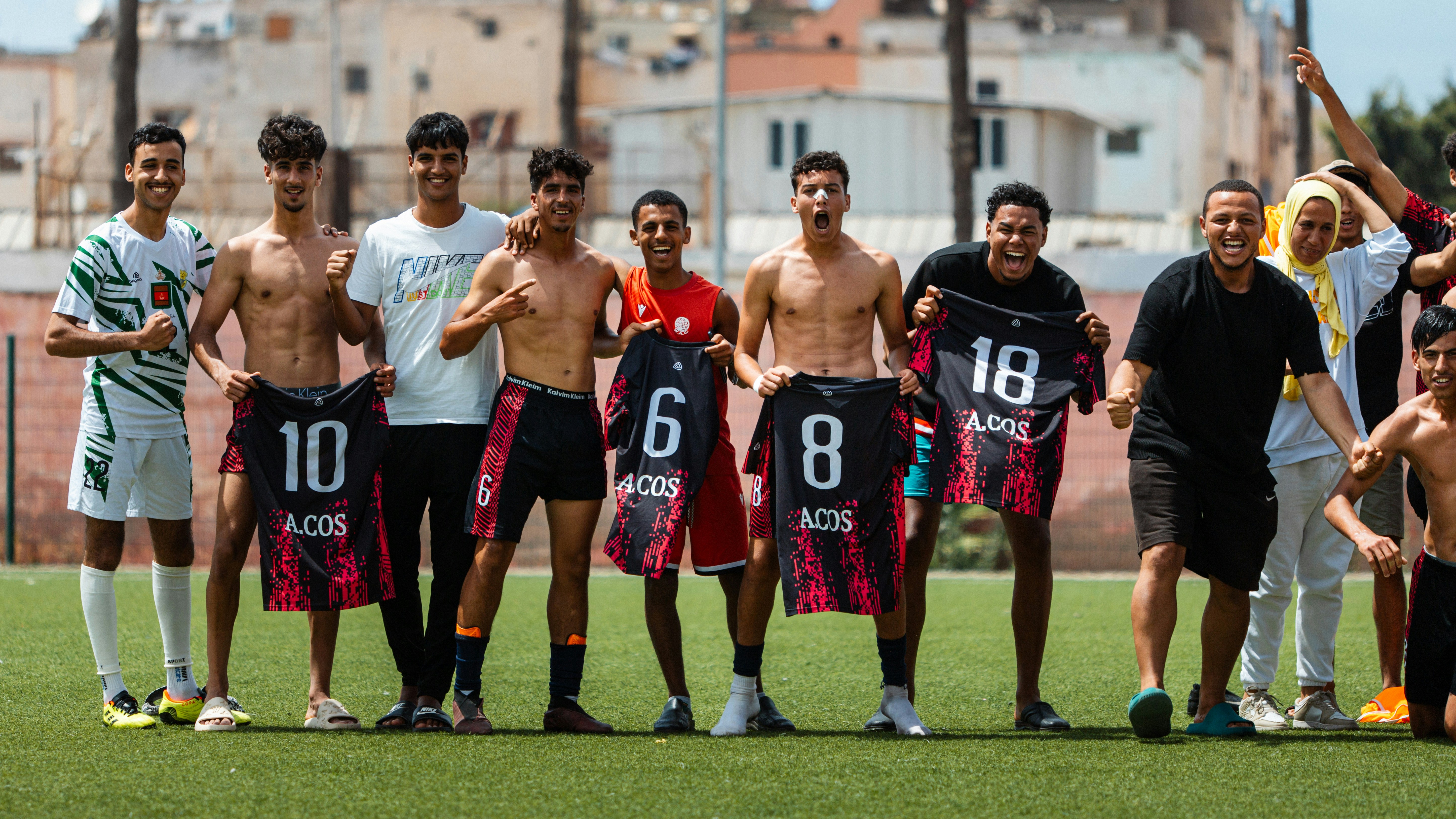Soccer team poses with jersey numbers.