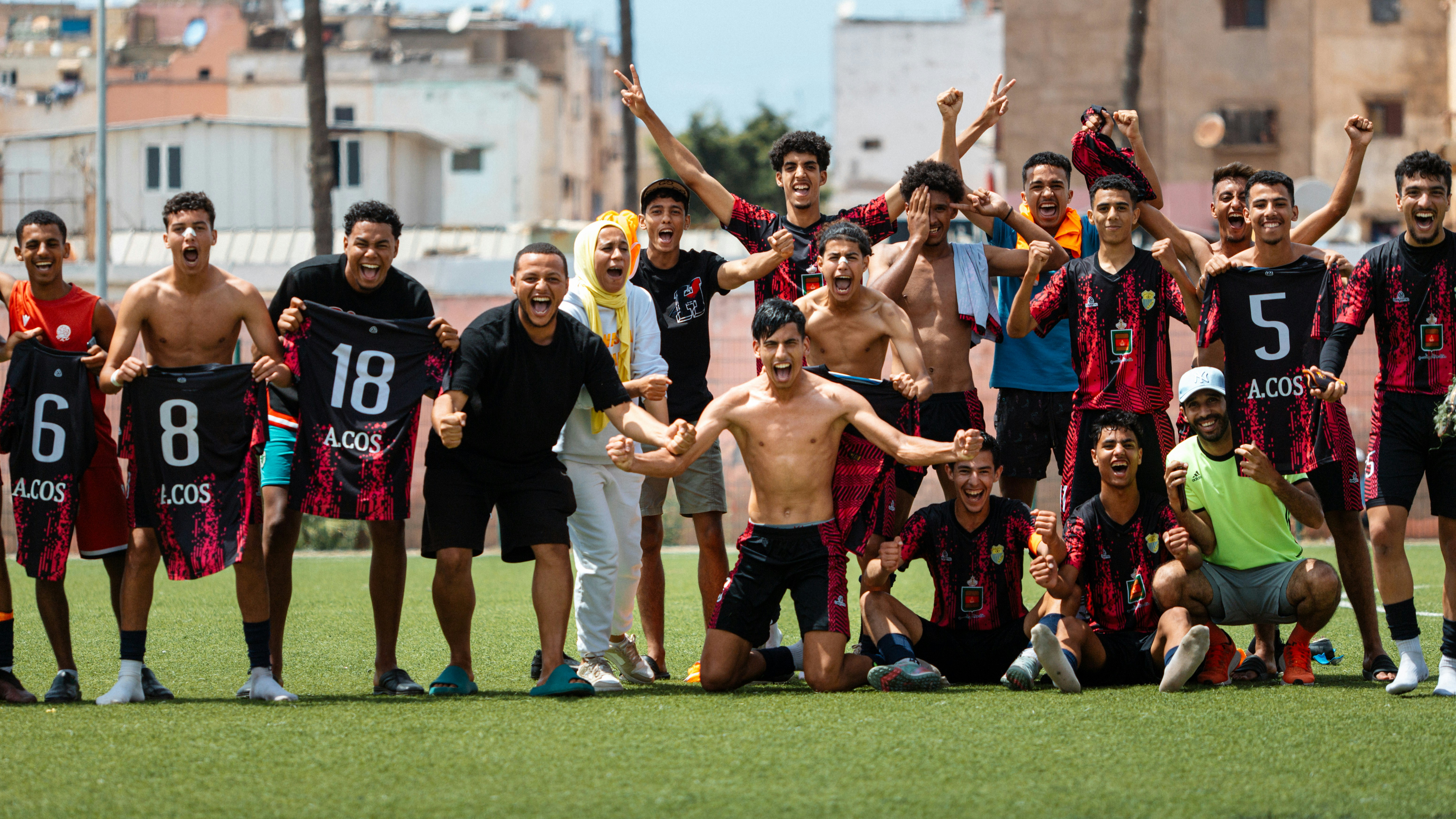A soccer team celebrates victory after the game.