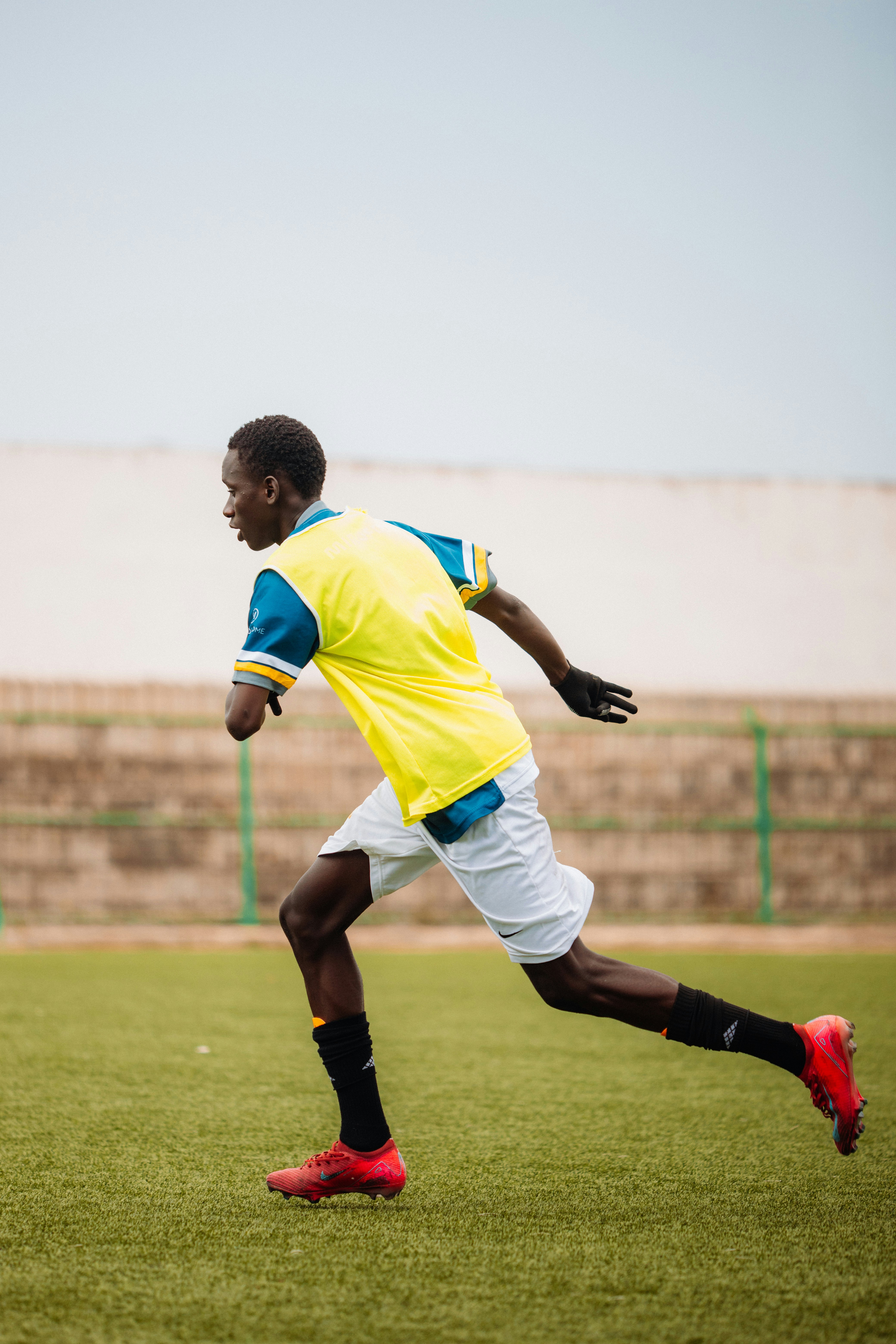 Soccer player running fast on the field.