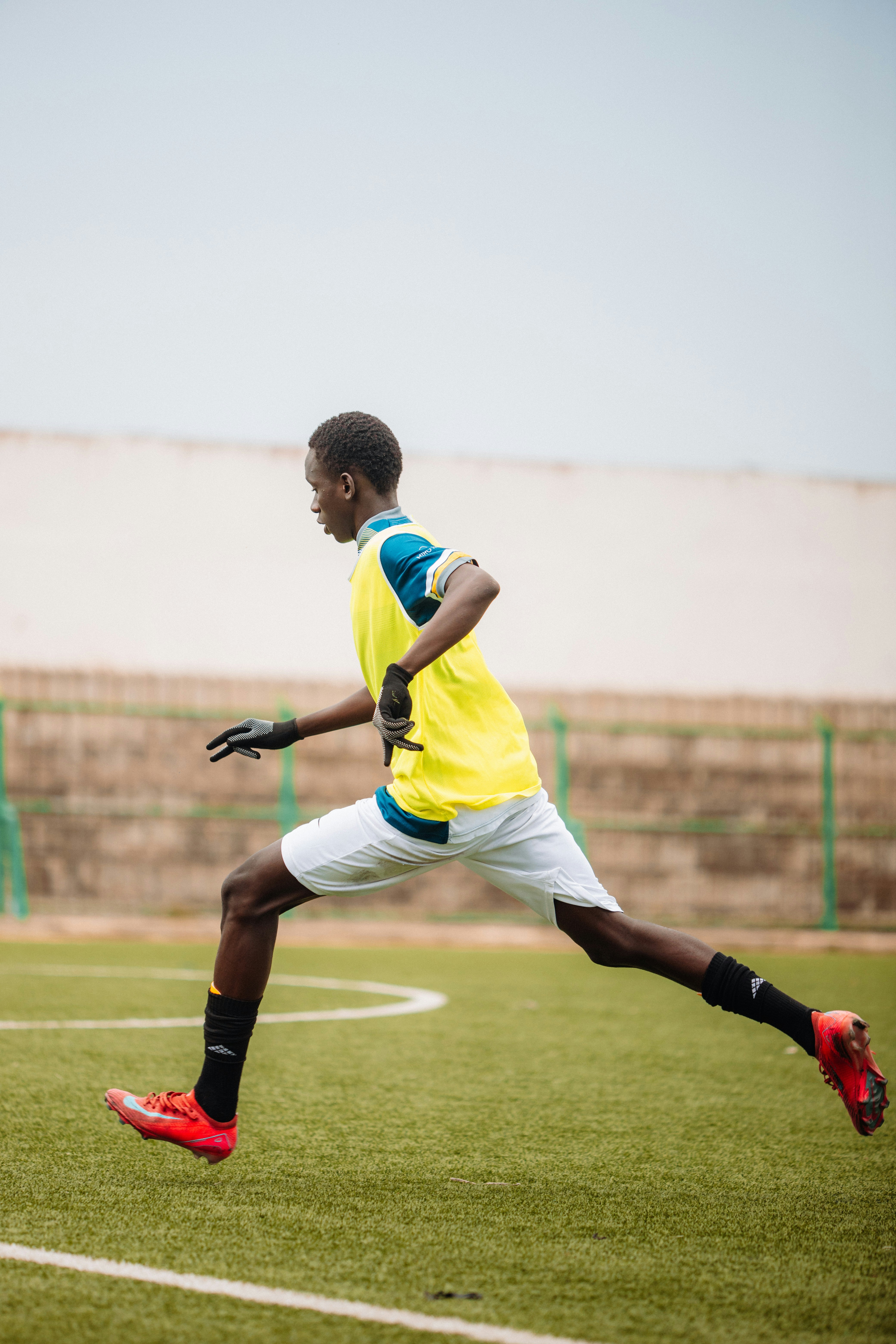 Soccer player runs on the field.