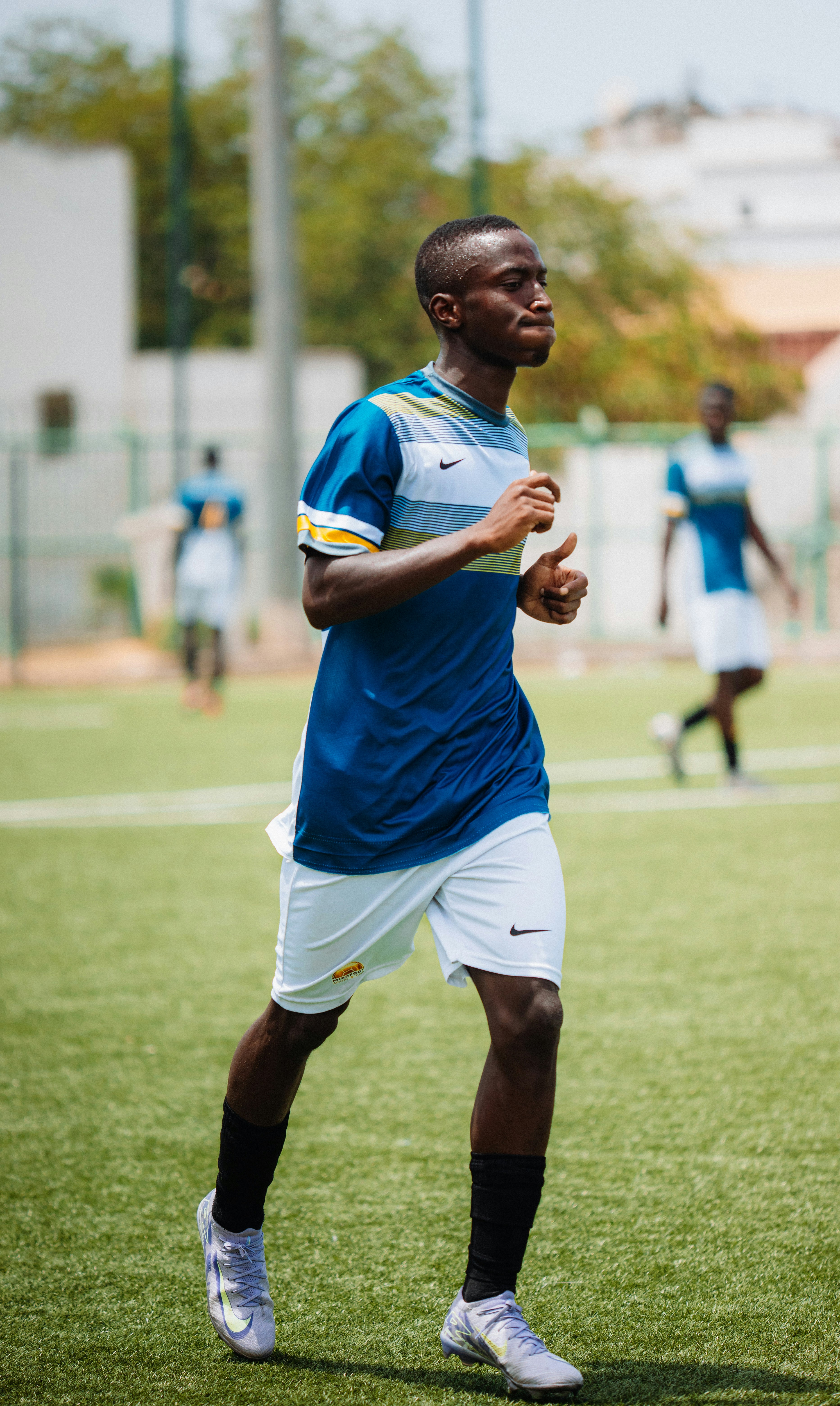 A soccer player runs on the field.