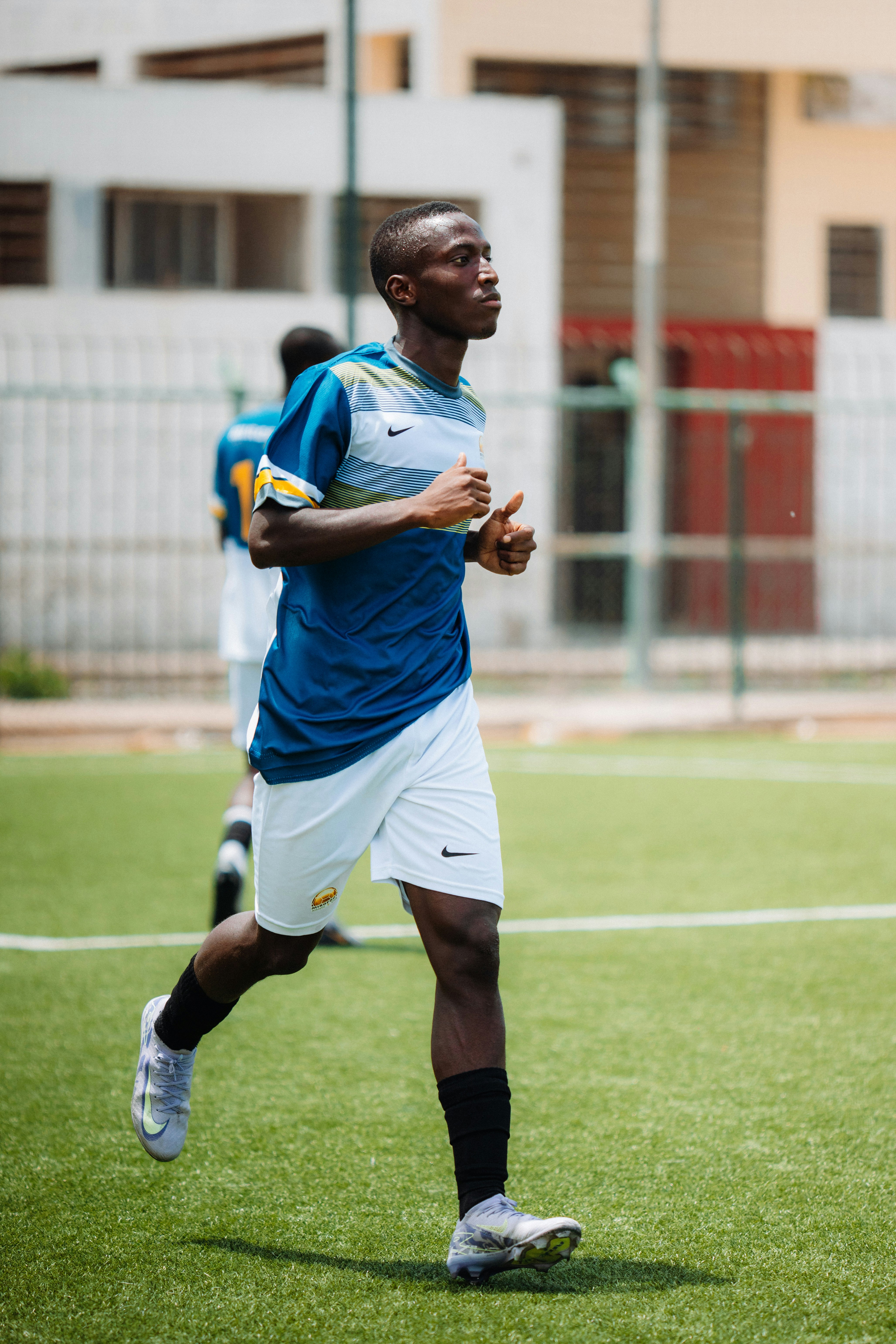 A soccer player runs on the field.