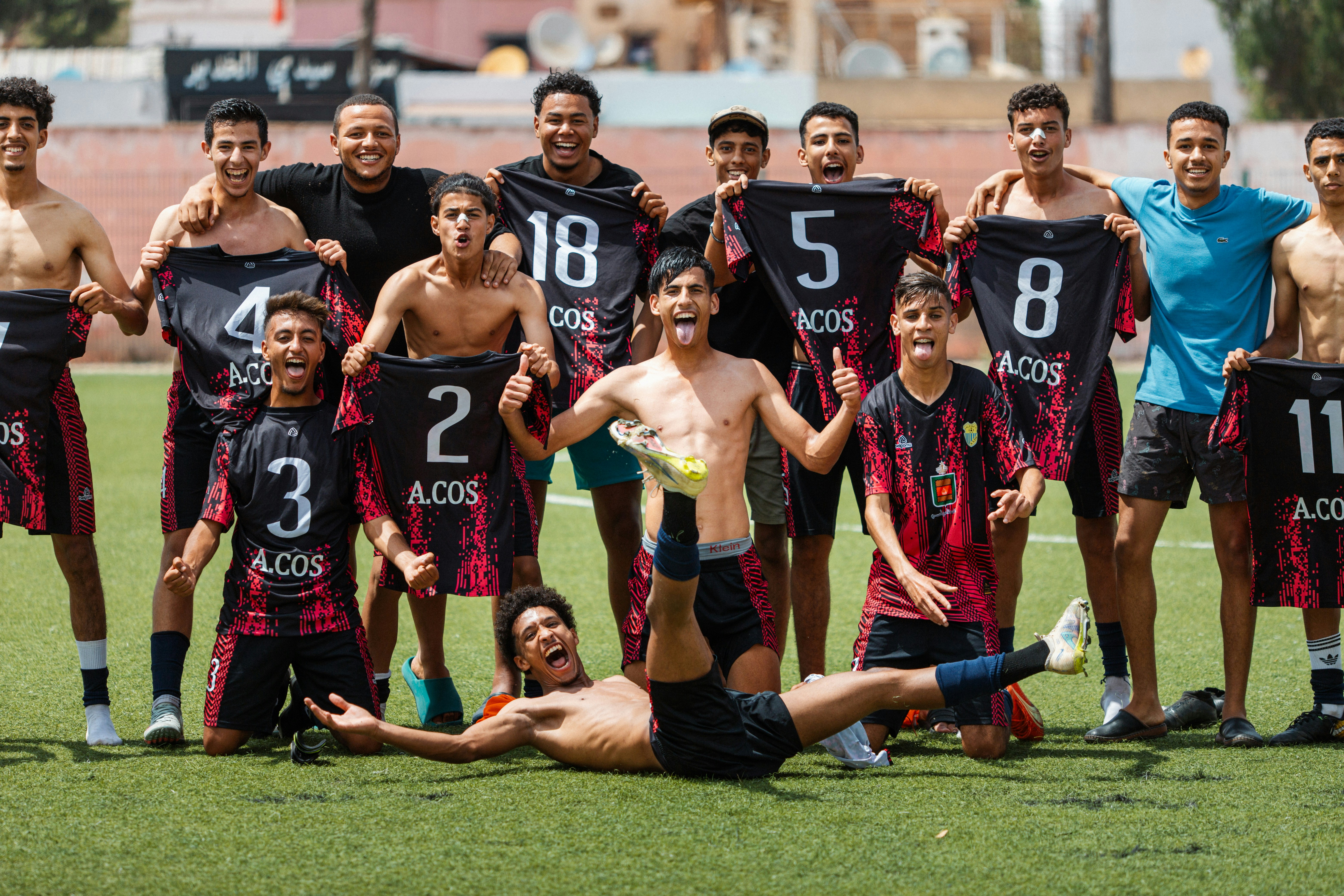Soccer team celebrates a victory on the field.