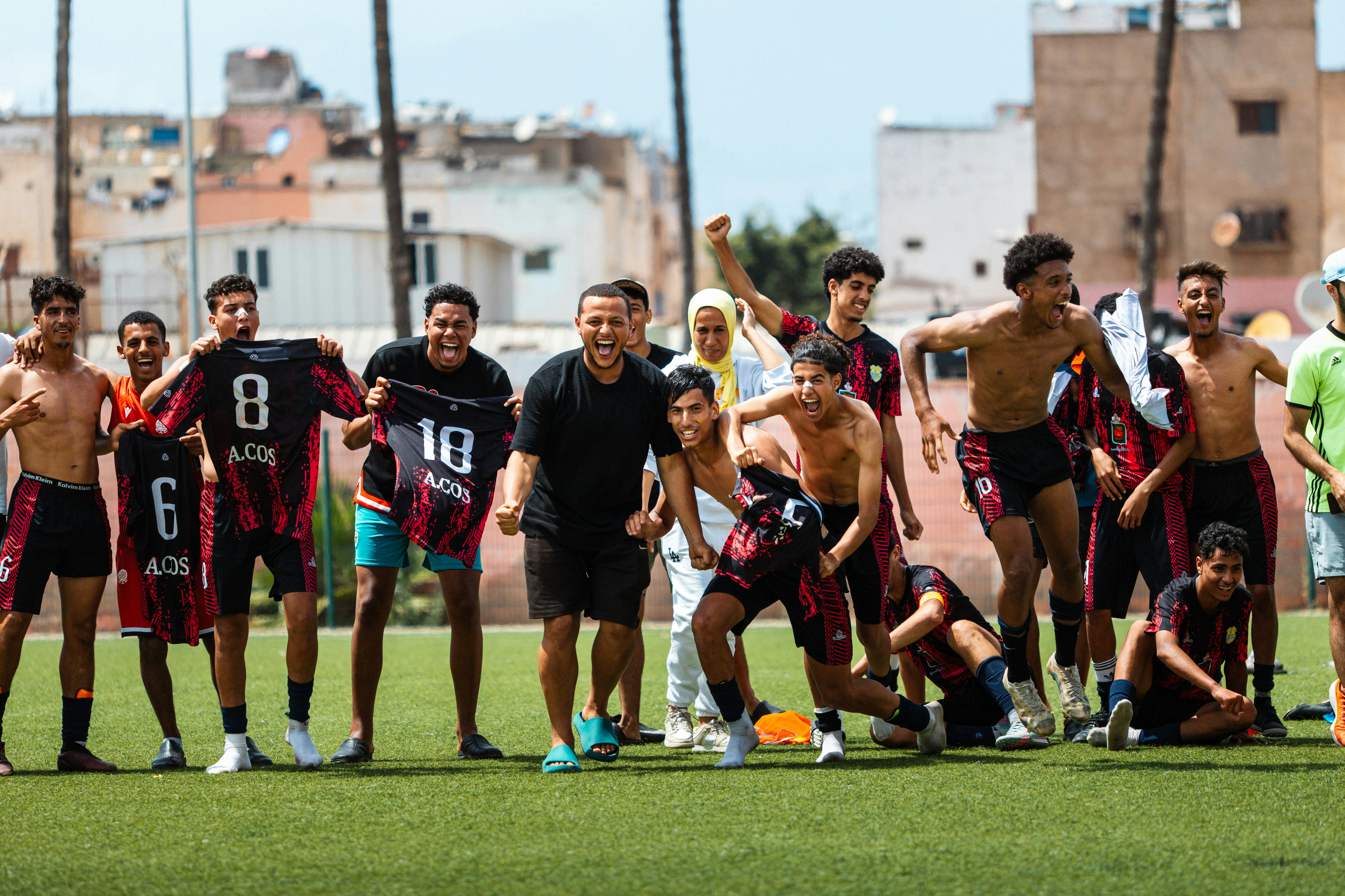 Soccer team celebrates a victory on the field.