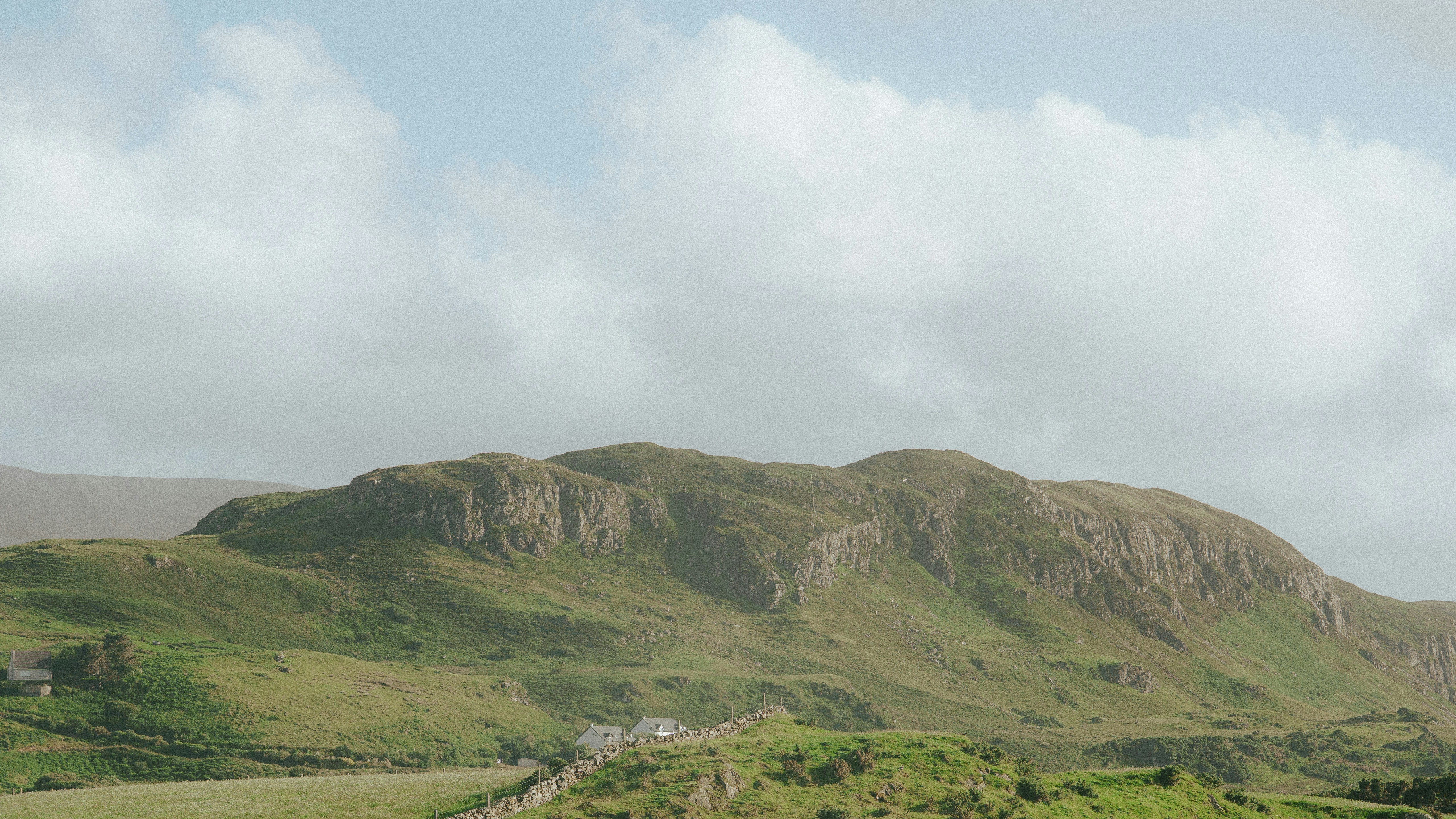 Hilly landscape with some cloud cover.