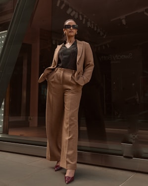 Stylish woman in a tailored pantsuit and sunglasses.